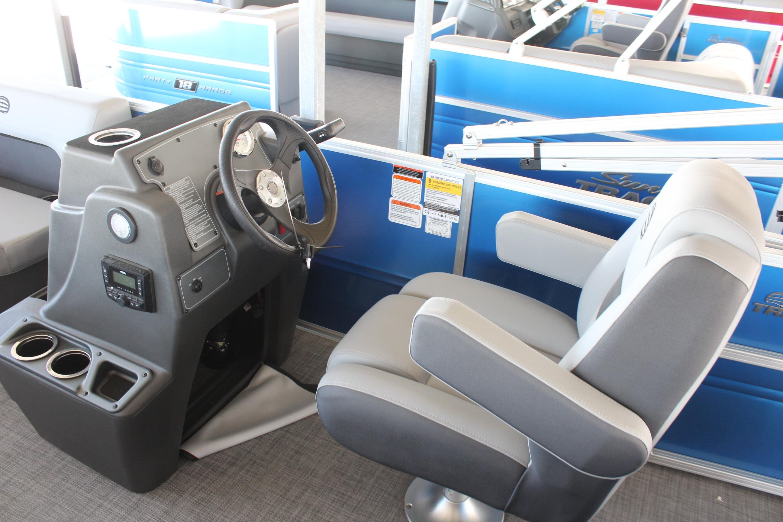 2026 Sun Tracker Party Barge 16 DLX interior with steering console and comfortable seating.