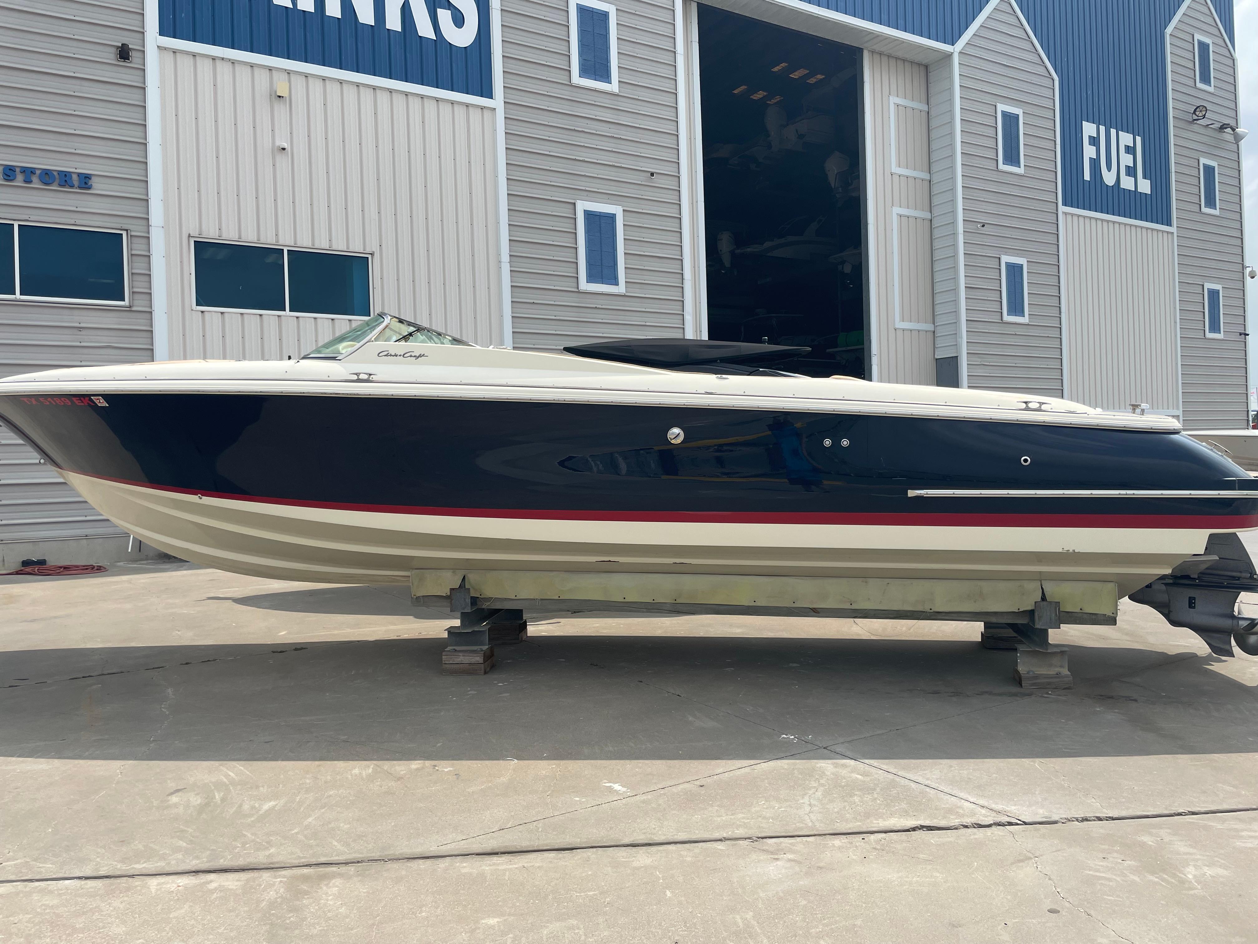 2013 Chris-Craft Launch 32 boat on dry dock outside a marina.