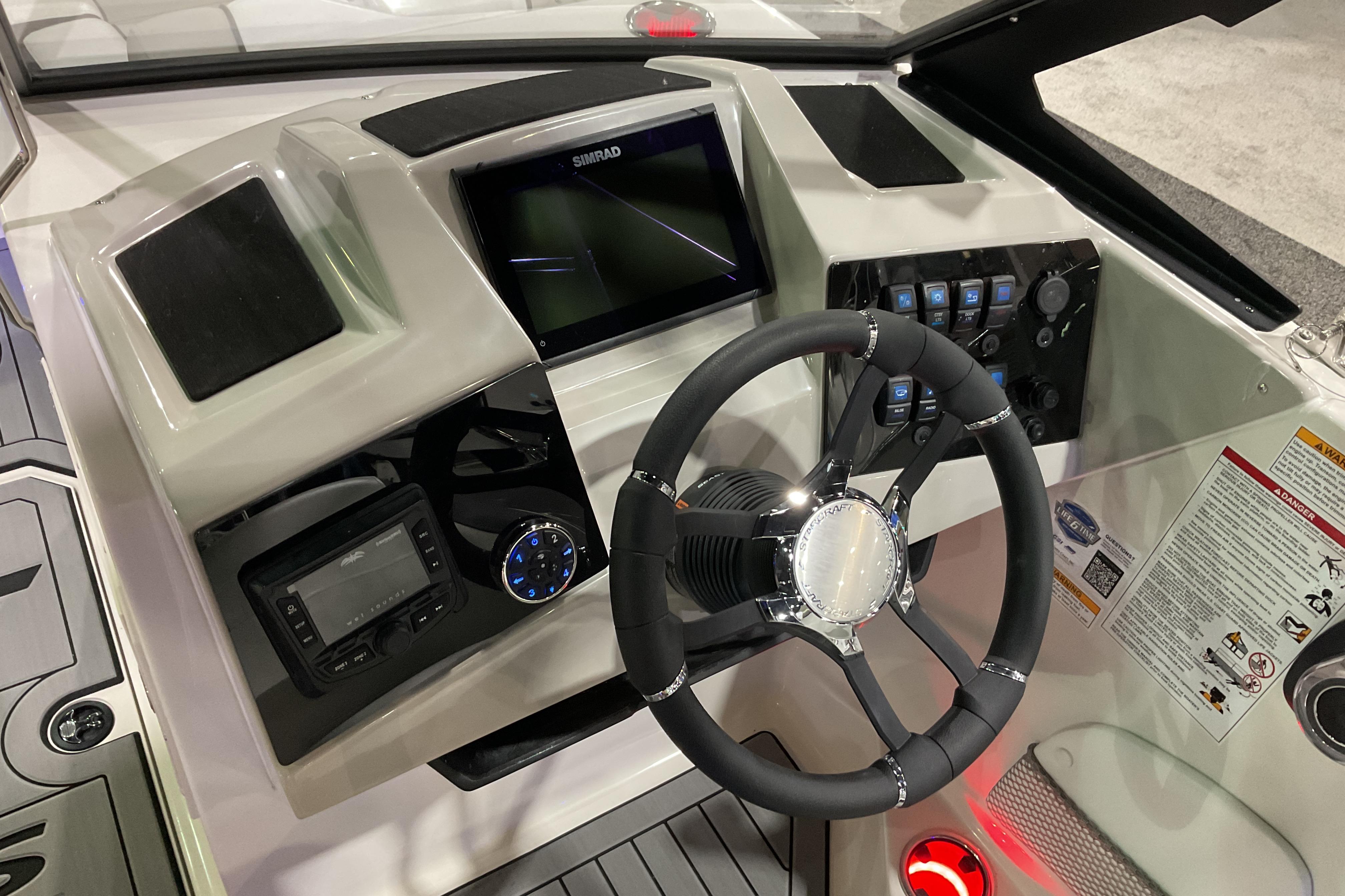 2026 Starcraft SVX 210 DC OB boat dashboard with steering wheel and control panel.