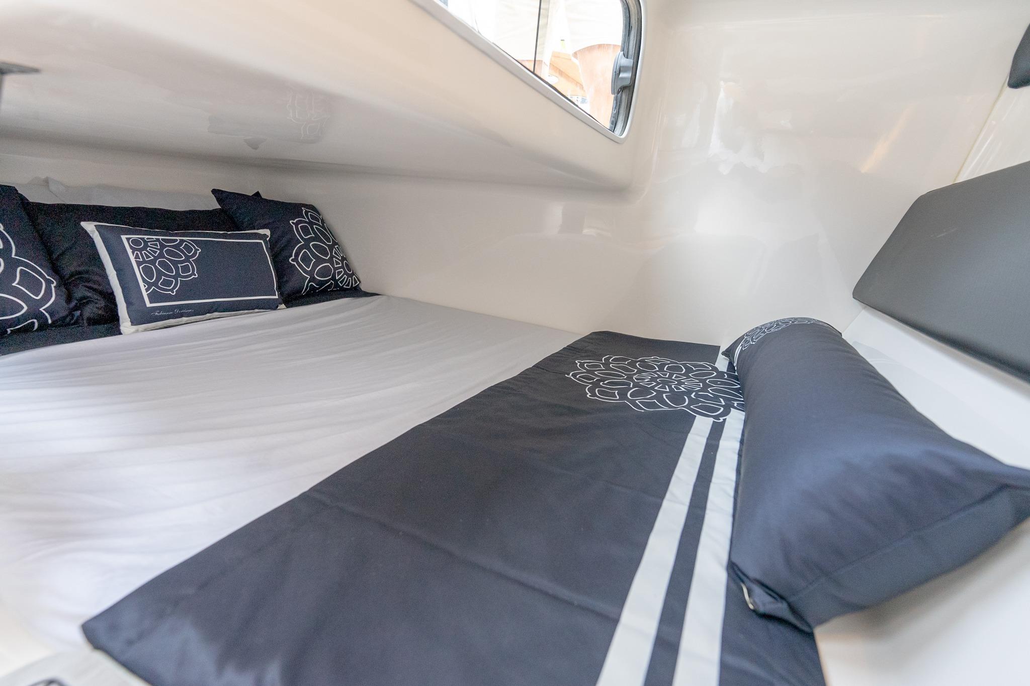 Cozy interior cabin of 2027 Hanover 305 with elegant bedding and pillows.