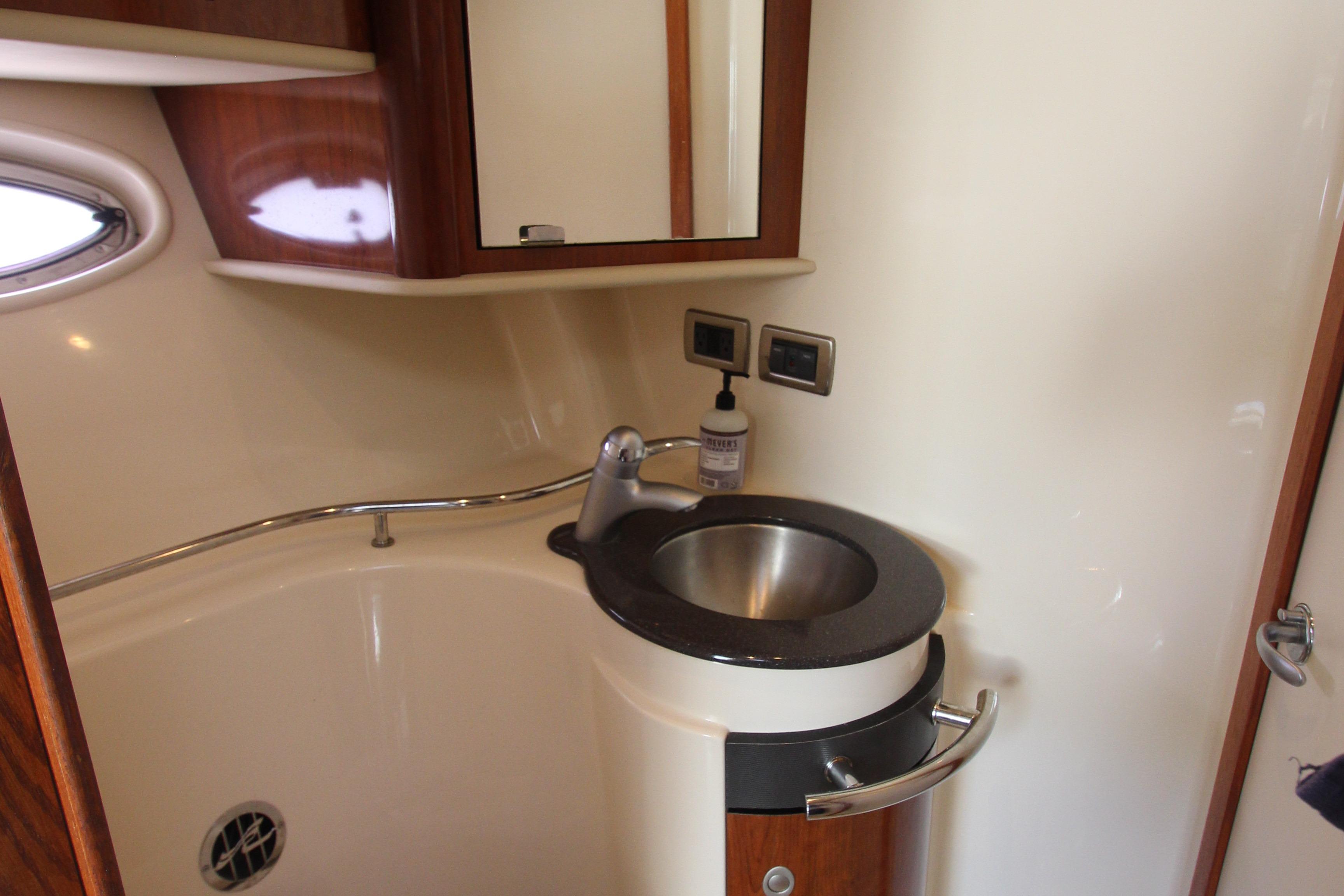 2004 Sea Ray 40 Sundancer bathroom with modern sink and wooden cabinetry.