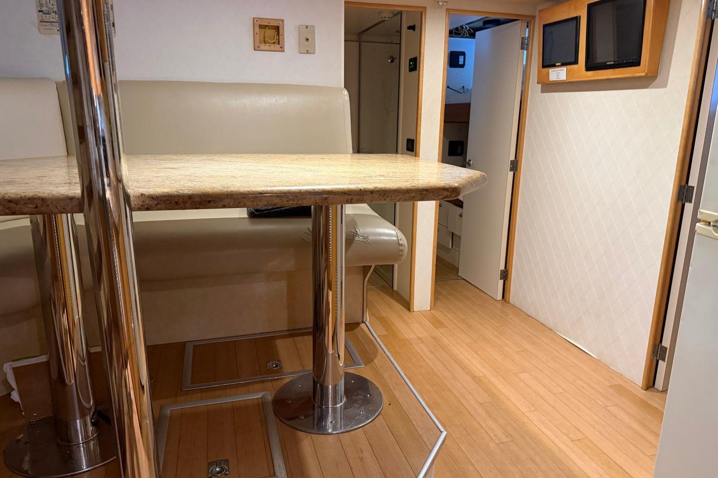Interior of 1990 Heesen 144 yacht with modern seating and wooden flooring.
