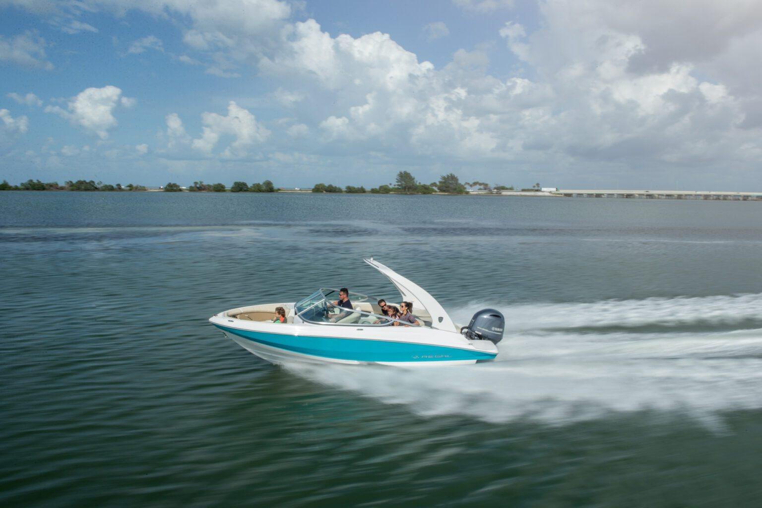 2026 Regal 21 OBX speedboat cruising on a sunny day, creating a wake.
