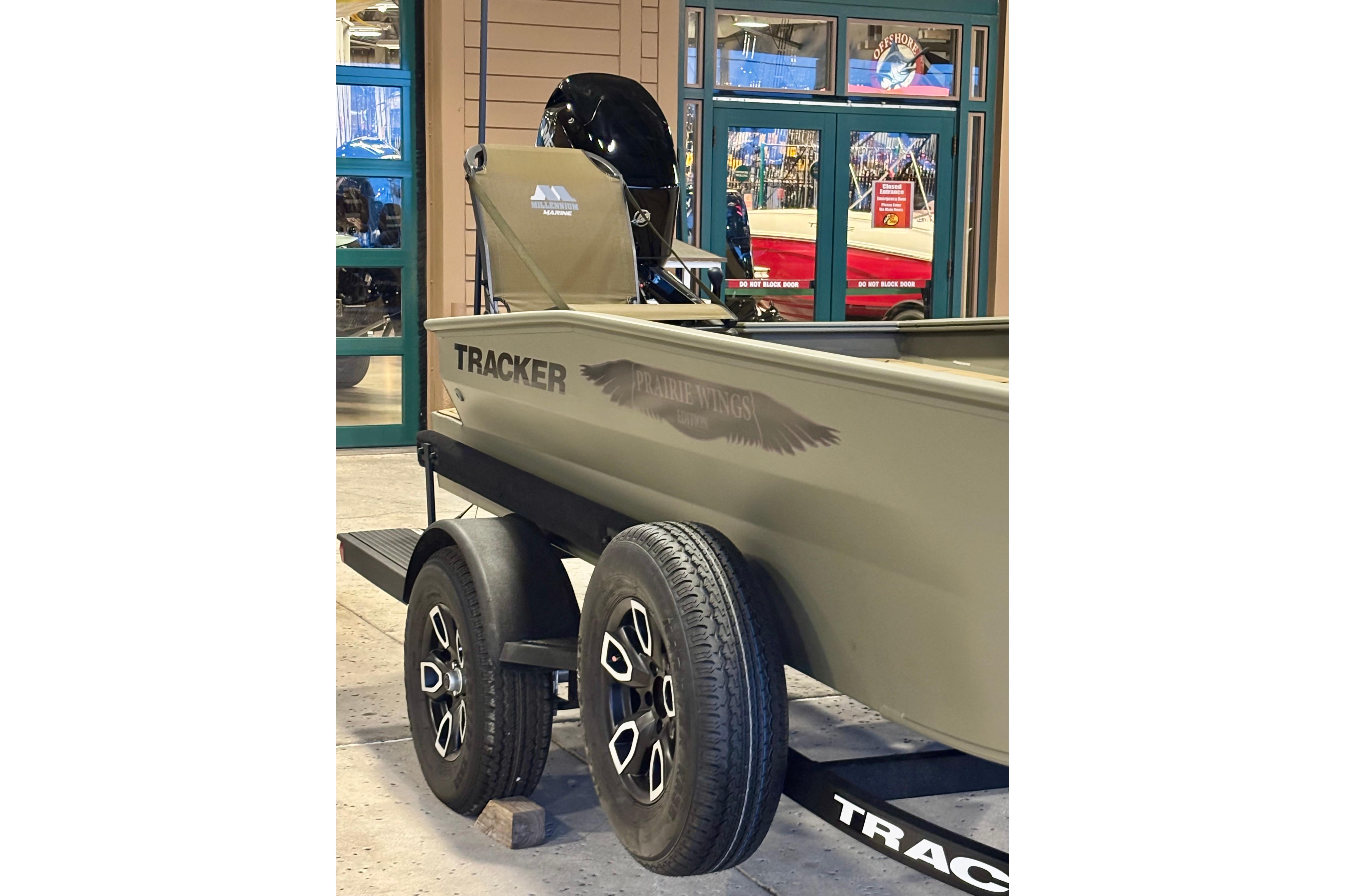 2026 Tracker Grizzly 1650 T Prairie Wings Edition boat on trailer, displayed indoors.