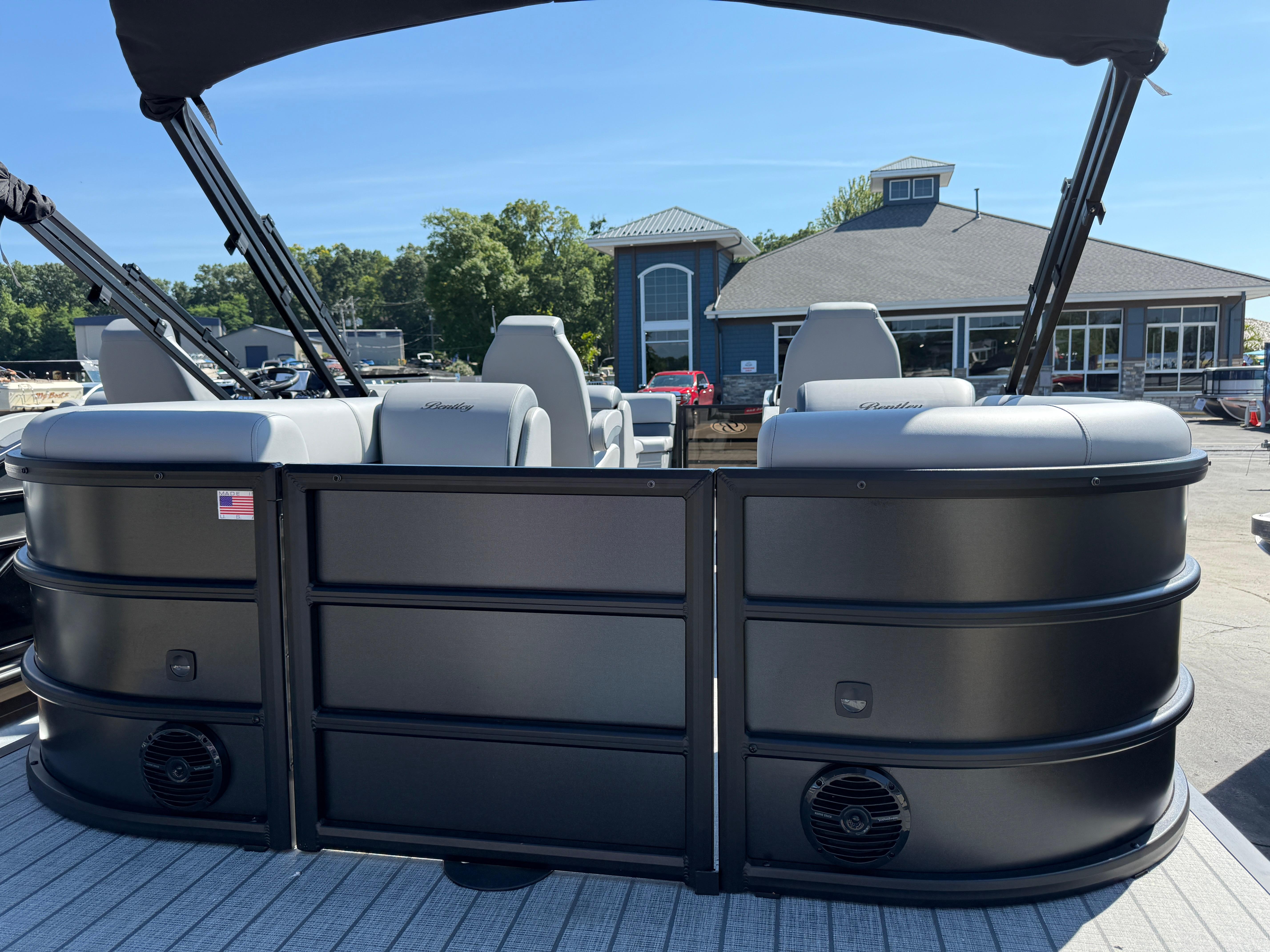 2026 Bentley Pontoons Legacy 223 Navigator at dock, featuring sleek design and comfortable seating.