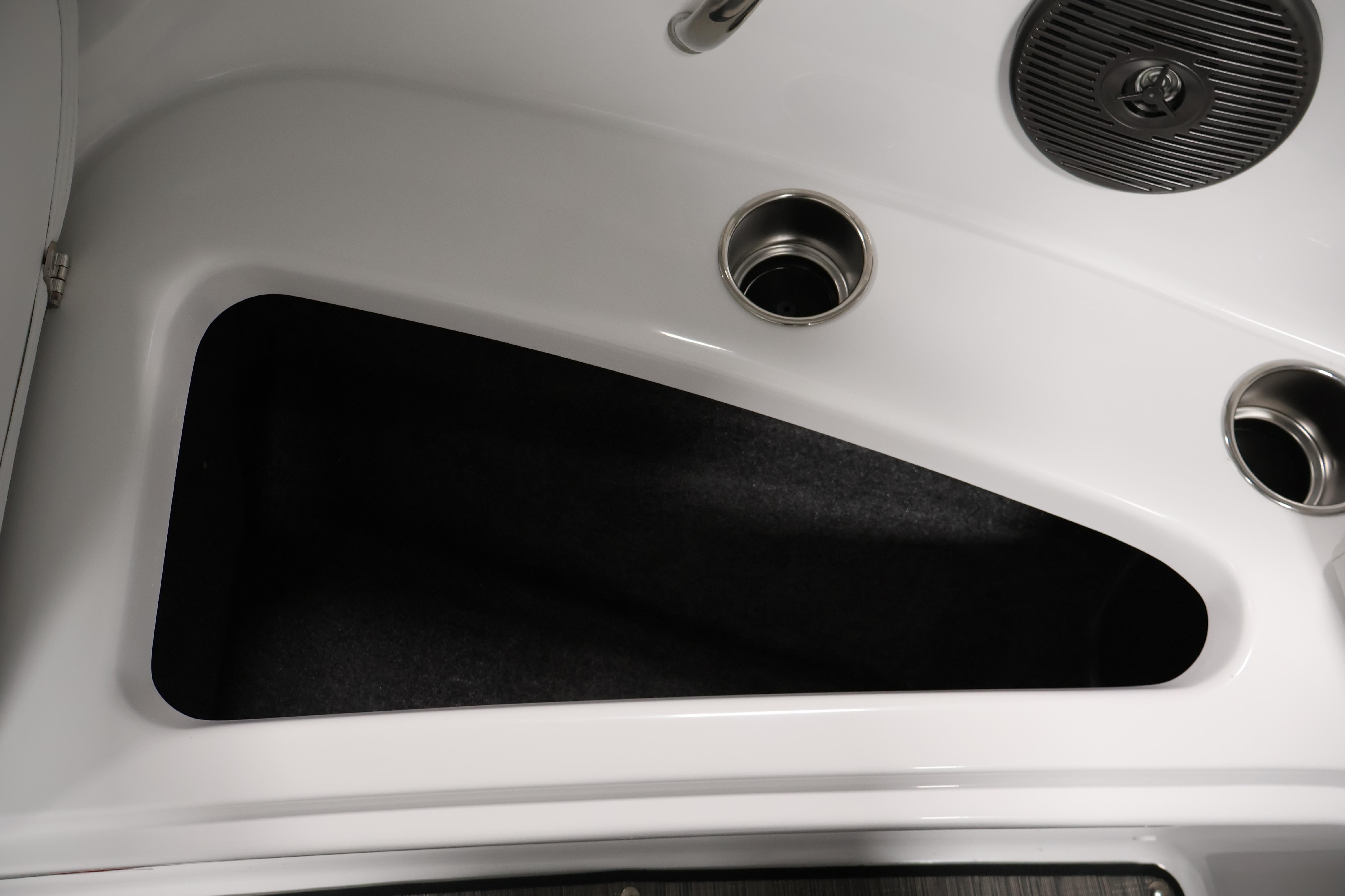 Interior storage compartment of 2026 Four Winns H4 Freedom boat with cup holders.