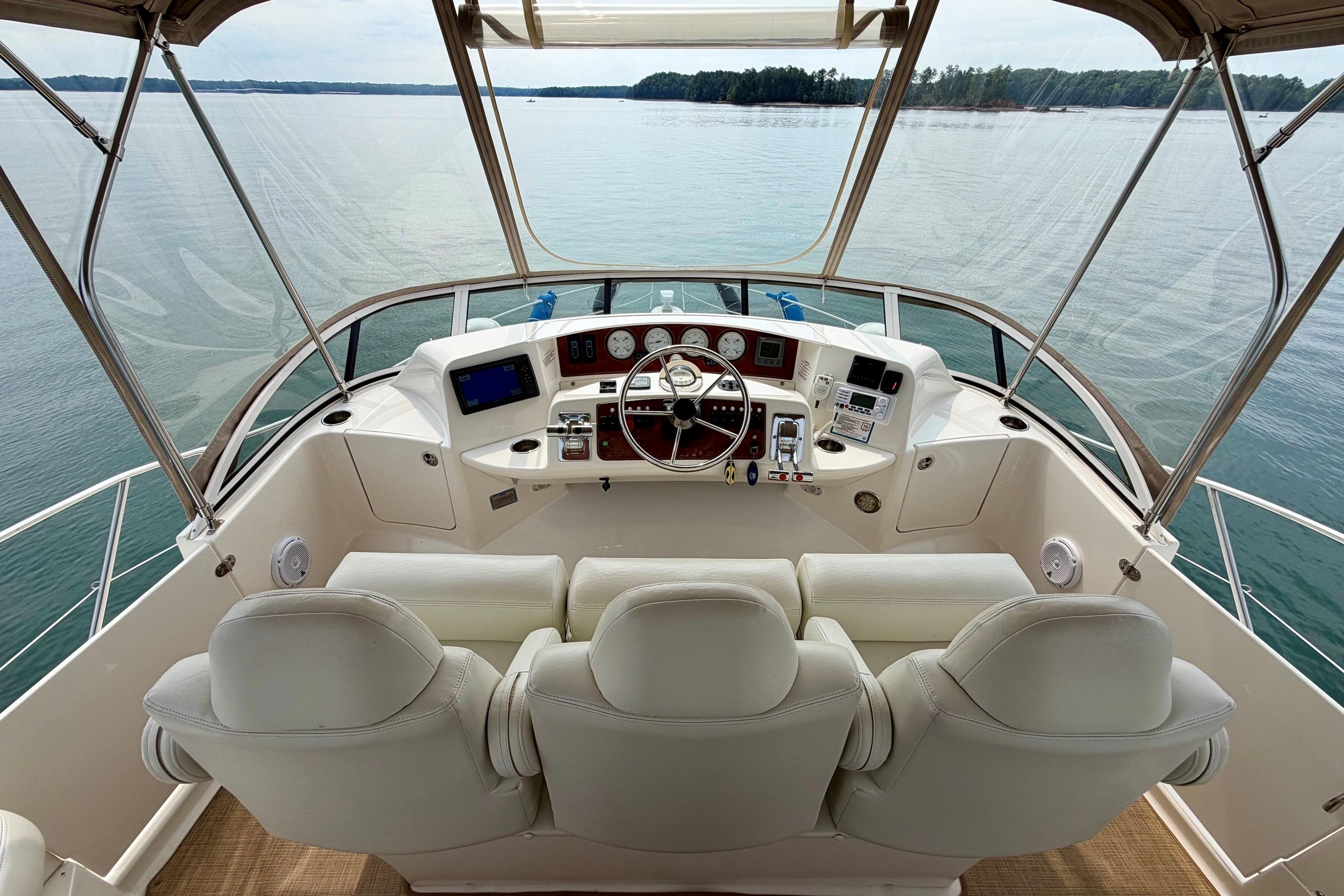 2004 Silverton 39 Motor Yacht helm with panoramic water view and luxurious seating.