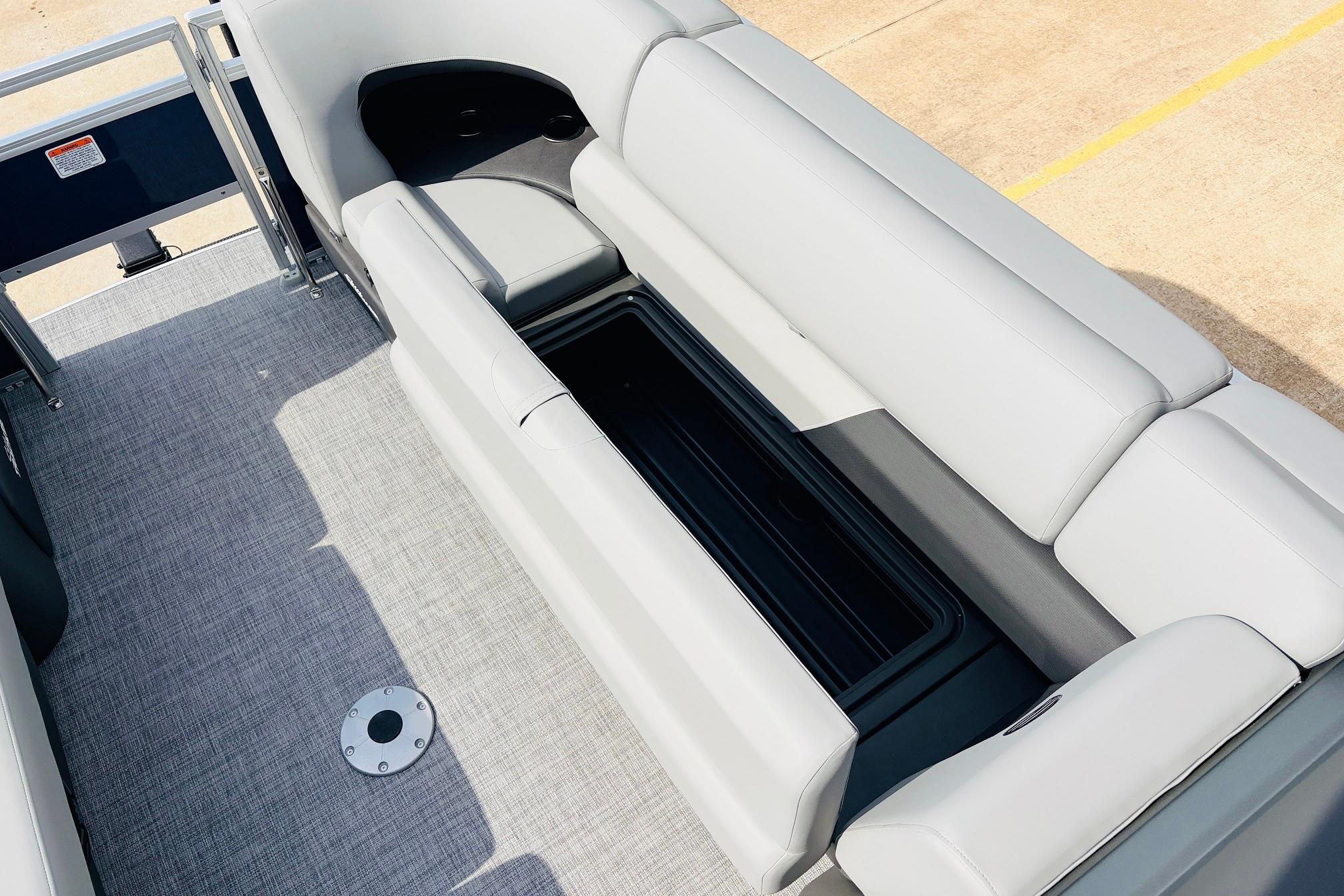 2026 Sun Tracker SportFish 22 DLX boat interior with gray seating and storage compartment.