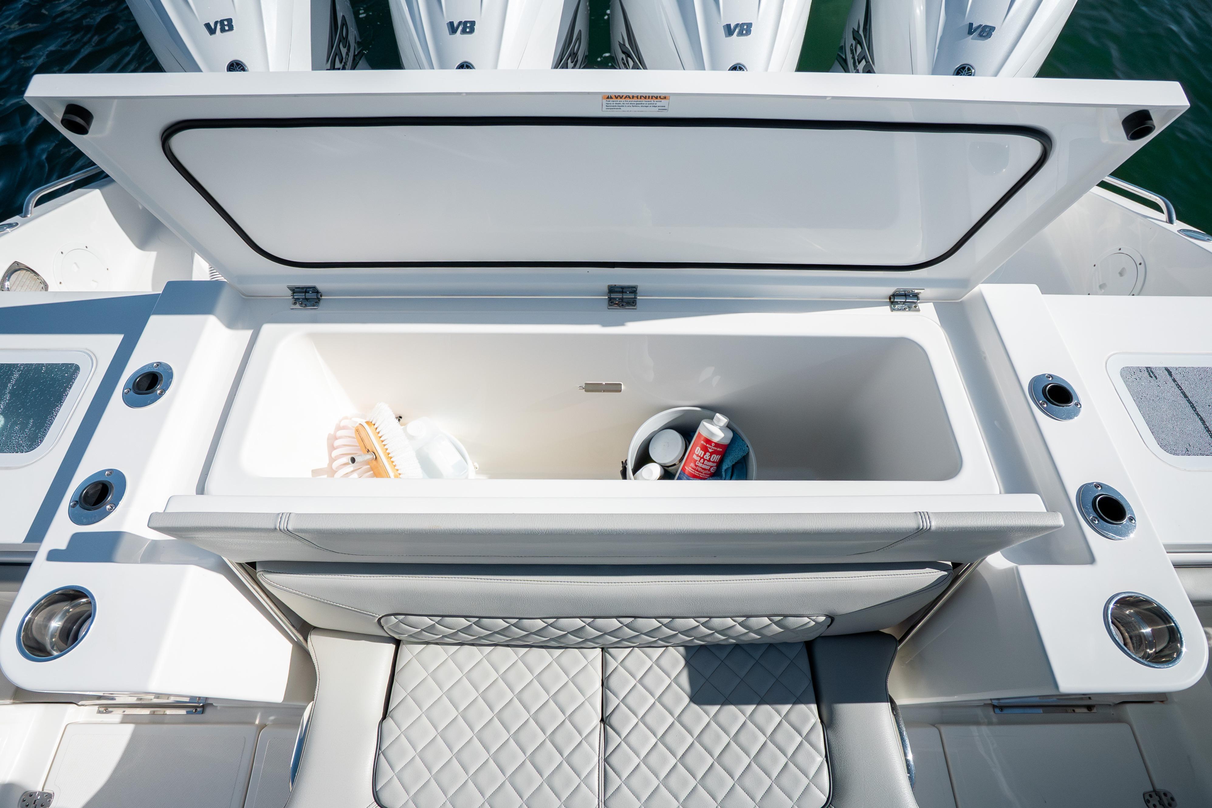 2023 Pursuit S 428 Sport boat storage compartment with open lid, showcasing interior space.