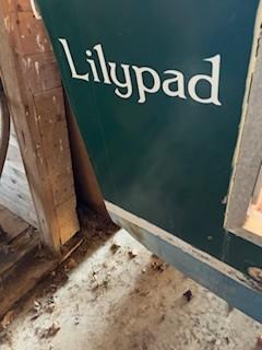 Green boat named "Lilypad" in a rustic setting, Custom North End Composites Point, 1990.