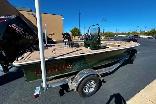 2026 Mako 18 Pro Skiff Backwater Edition on trailer, parked outdoors under clear blue sky.