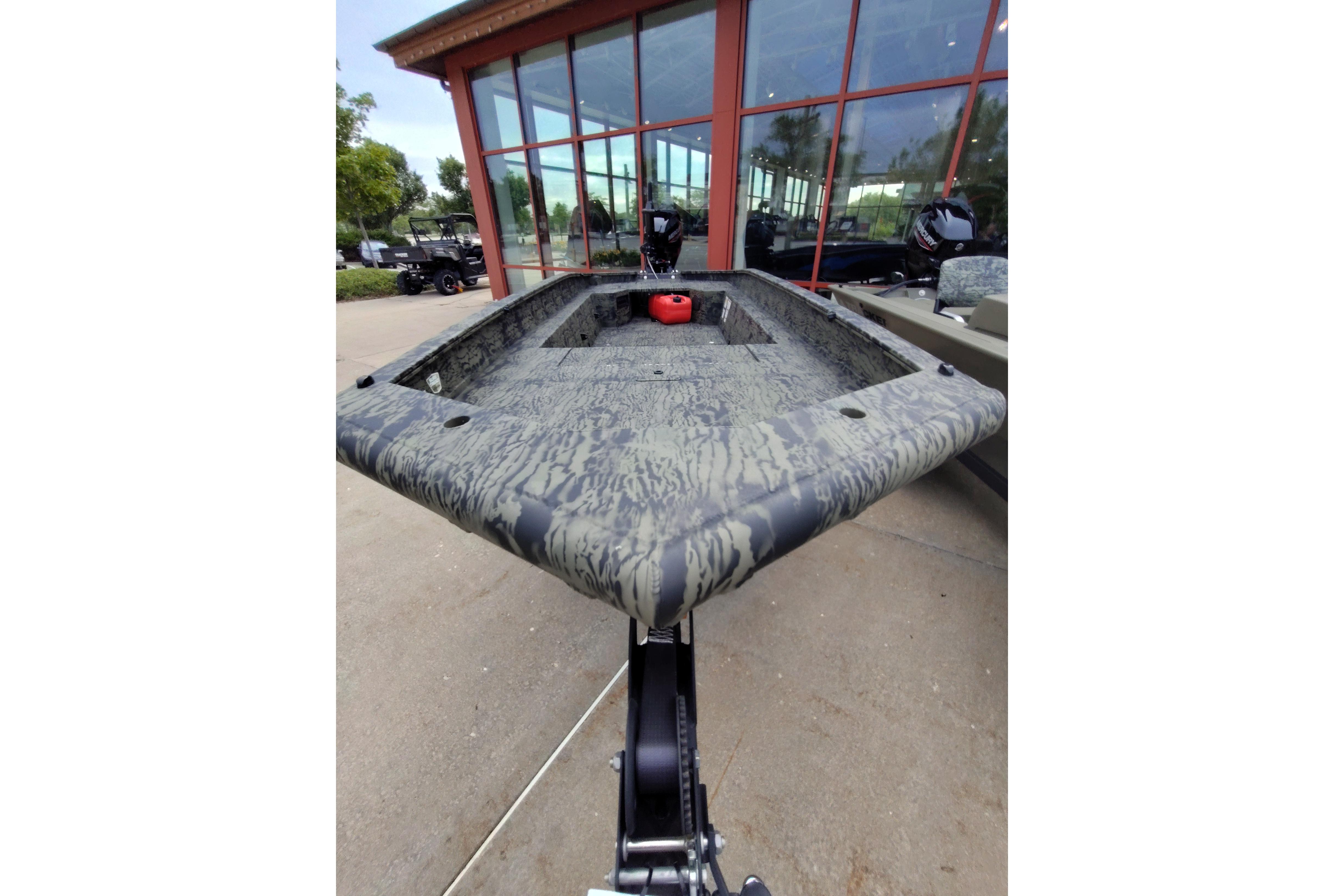 2026 Tracker Grizzly 1650 T Prairie Wings Edition boat with camouflage design, displayed outdoors.