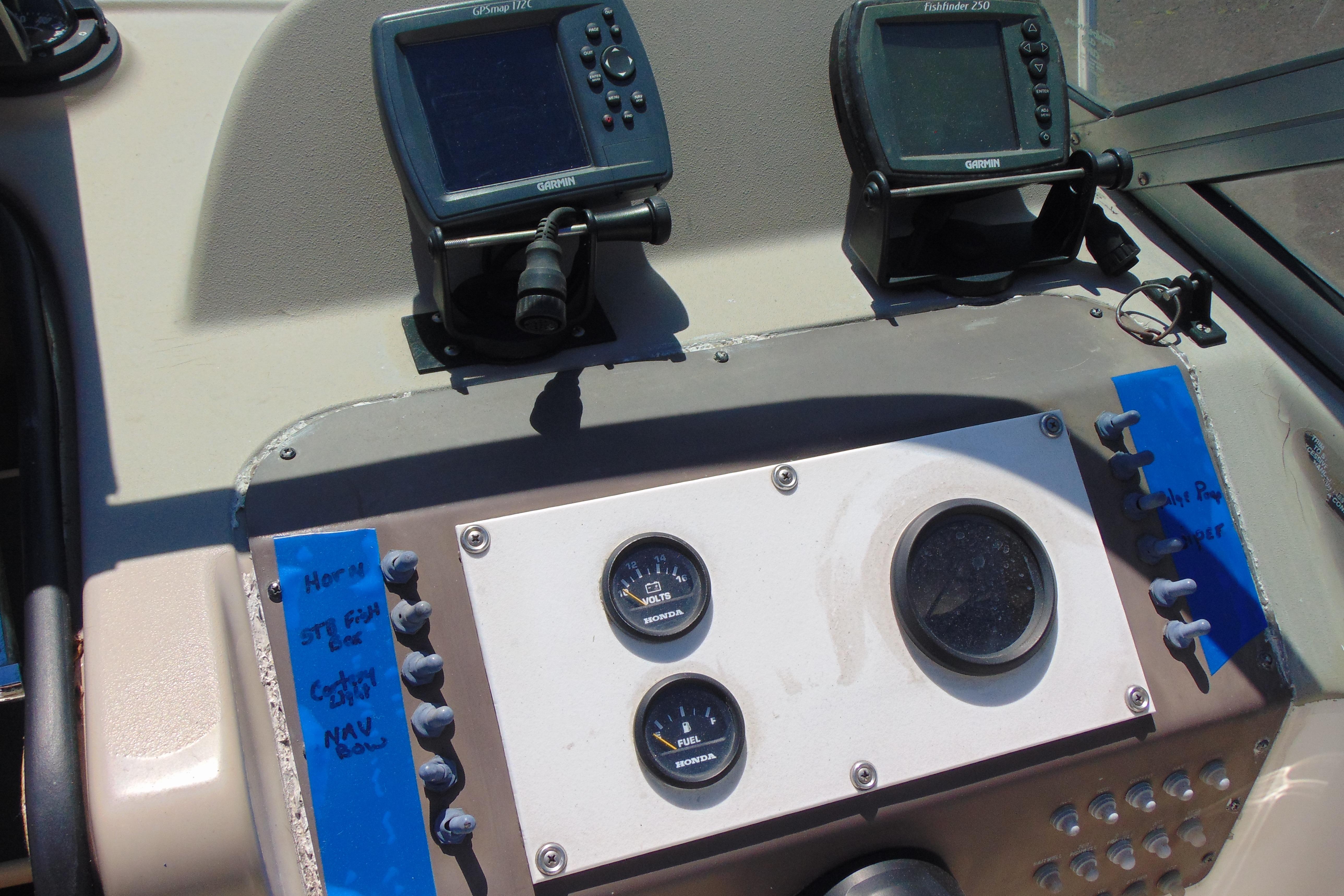 Dashboard of a 2002 Trophy Walkaround boat with navigation instruments and gauges.