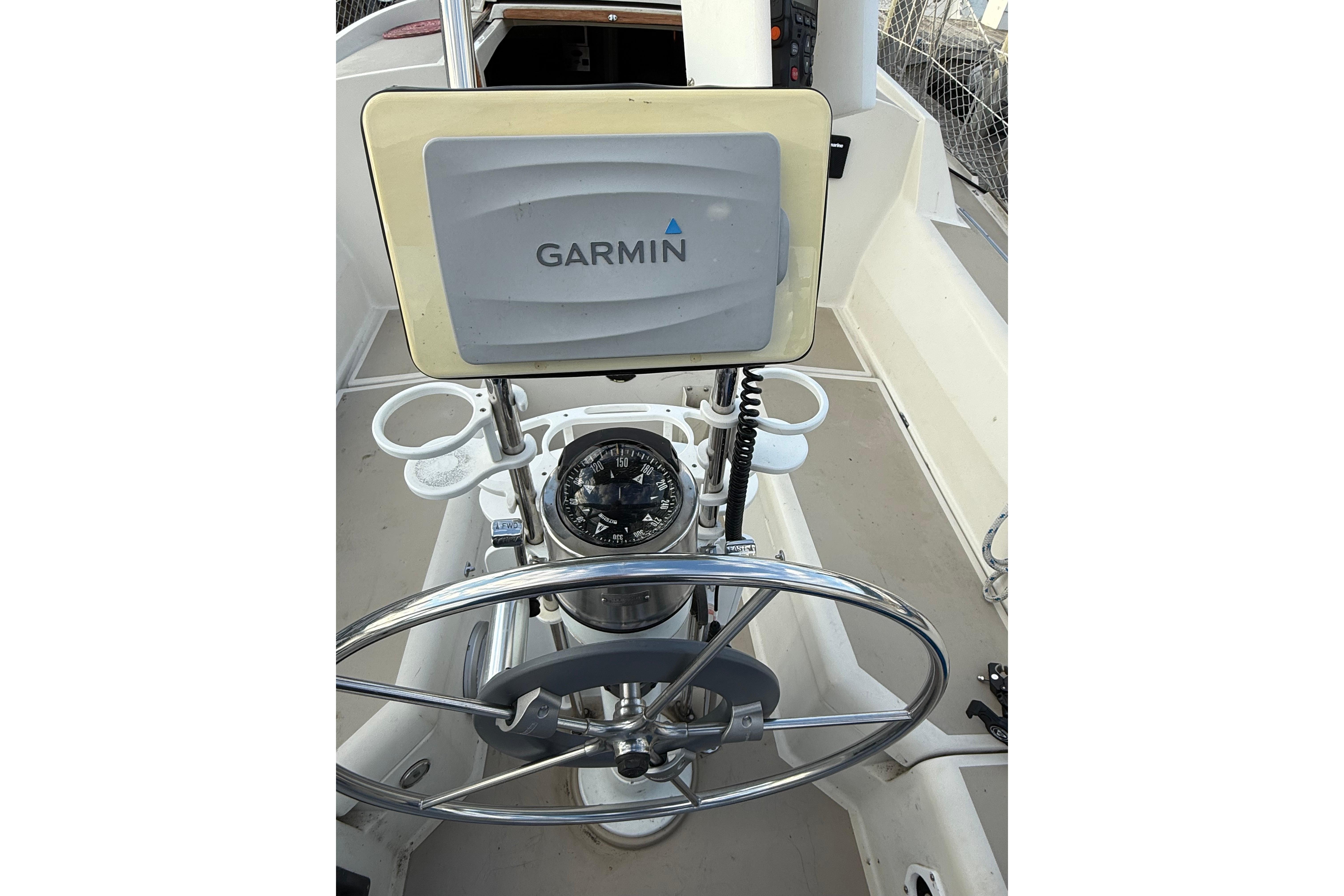 Cockpit of 1983 O'Day 34 sailboat with Garmin navigation system and compass.