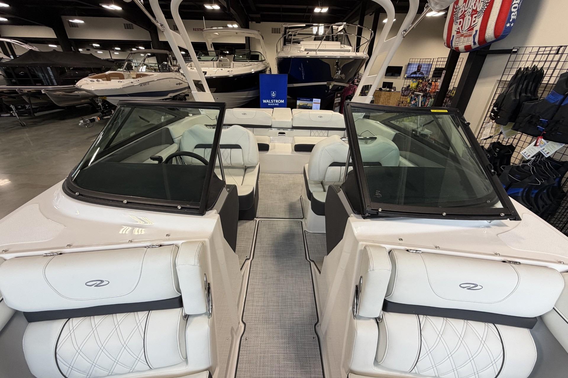 2027 Regal LS2 boat interior with white seating, displayed in a showroom.