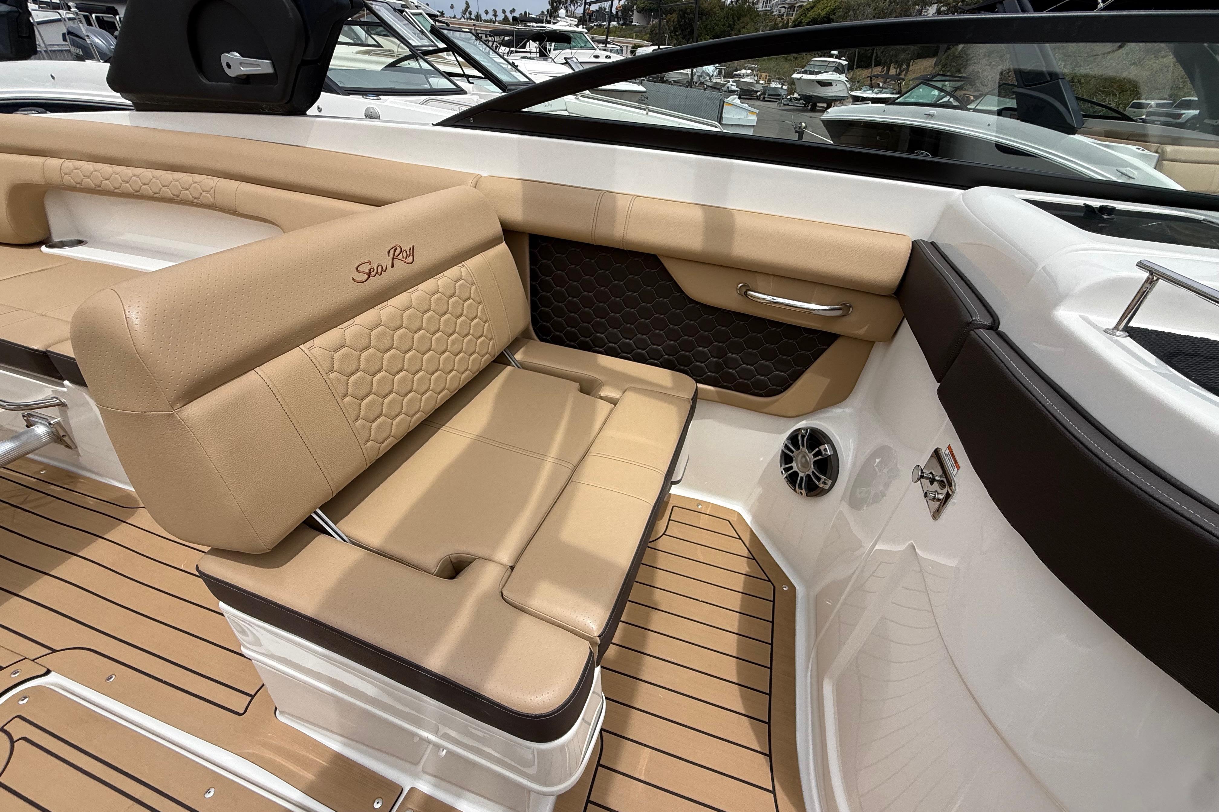 Luxurious interior of 2022 Sea Ray SDX 290 Outboard with tan leather seating and wood flooring.