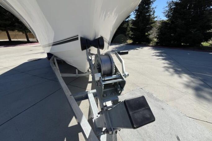 2025 Mako 214 Center Console boat on trailer, close-up of winch and bow.