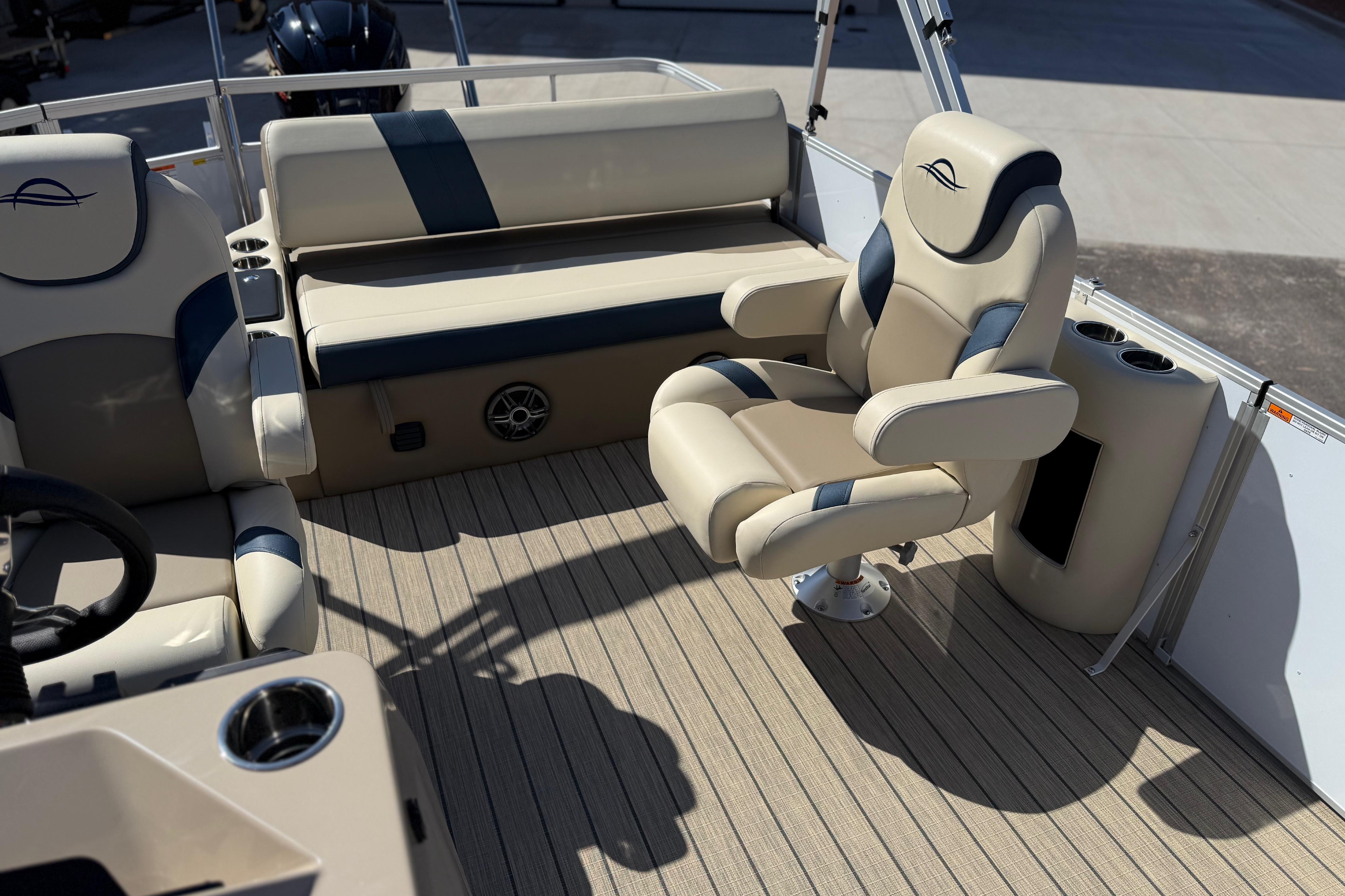 Luxurious seating on 2026 SunCatcher Select 322SL boat, featuring beige and blue upholstery.