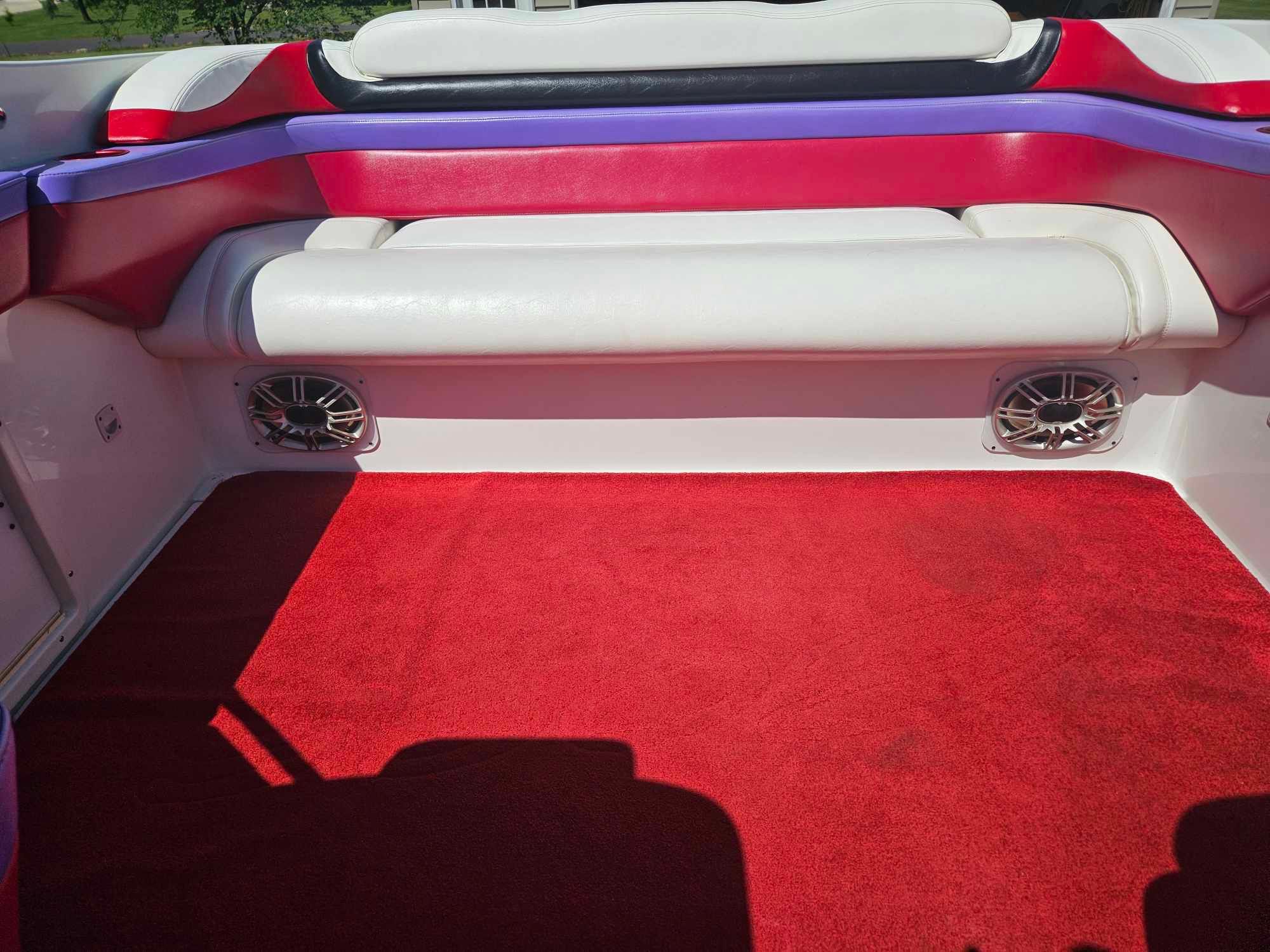 Interior of a 1997 Baja 38 Special Boss boat with red carpeting.