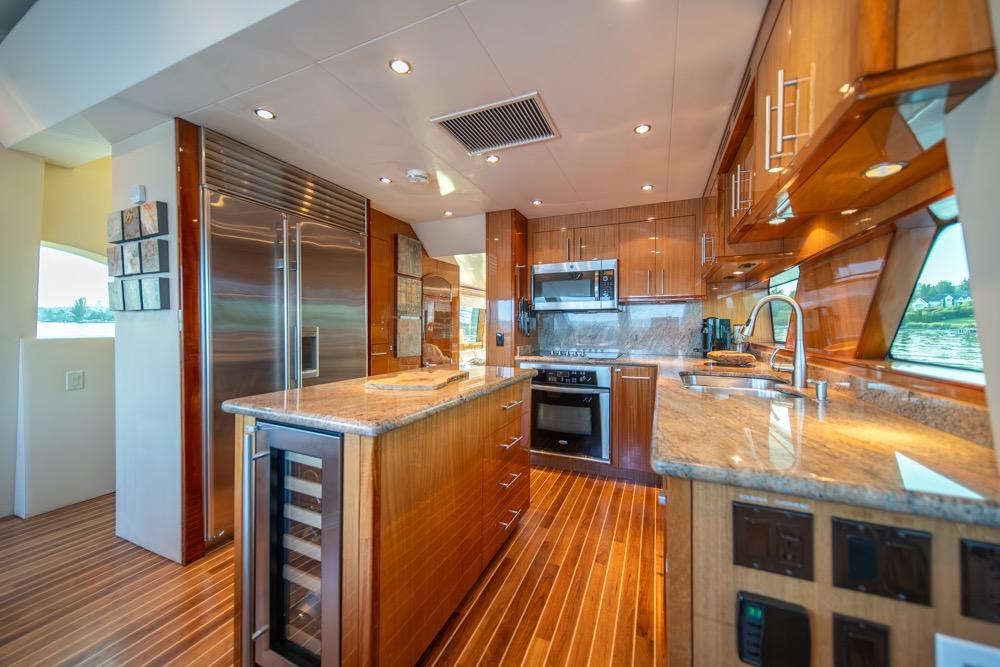 Luxurious kitchen interior of 2008 Hatteras 72 Motor Yacht with modern appliances and wood finishes.