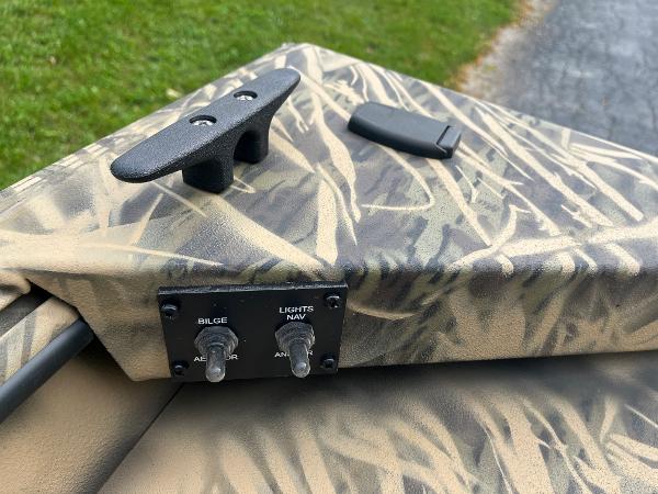 2024 Lowe Roughneck 1660 boat controls and cleat on camo deck.