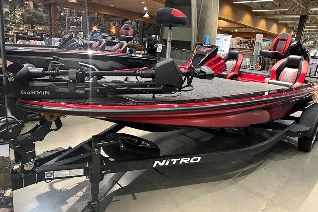 2026 Nitro Z20 XL Pro boat in showroom, featuring sleek red design and advanced Garmin equipment.