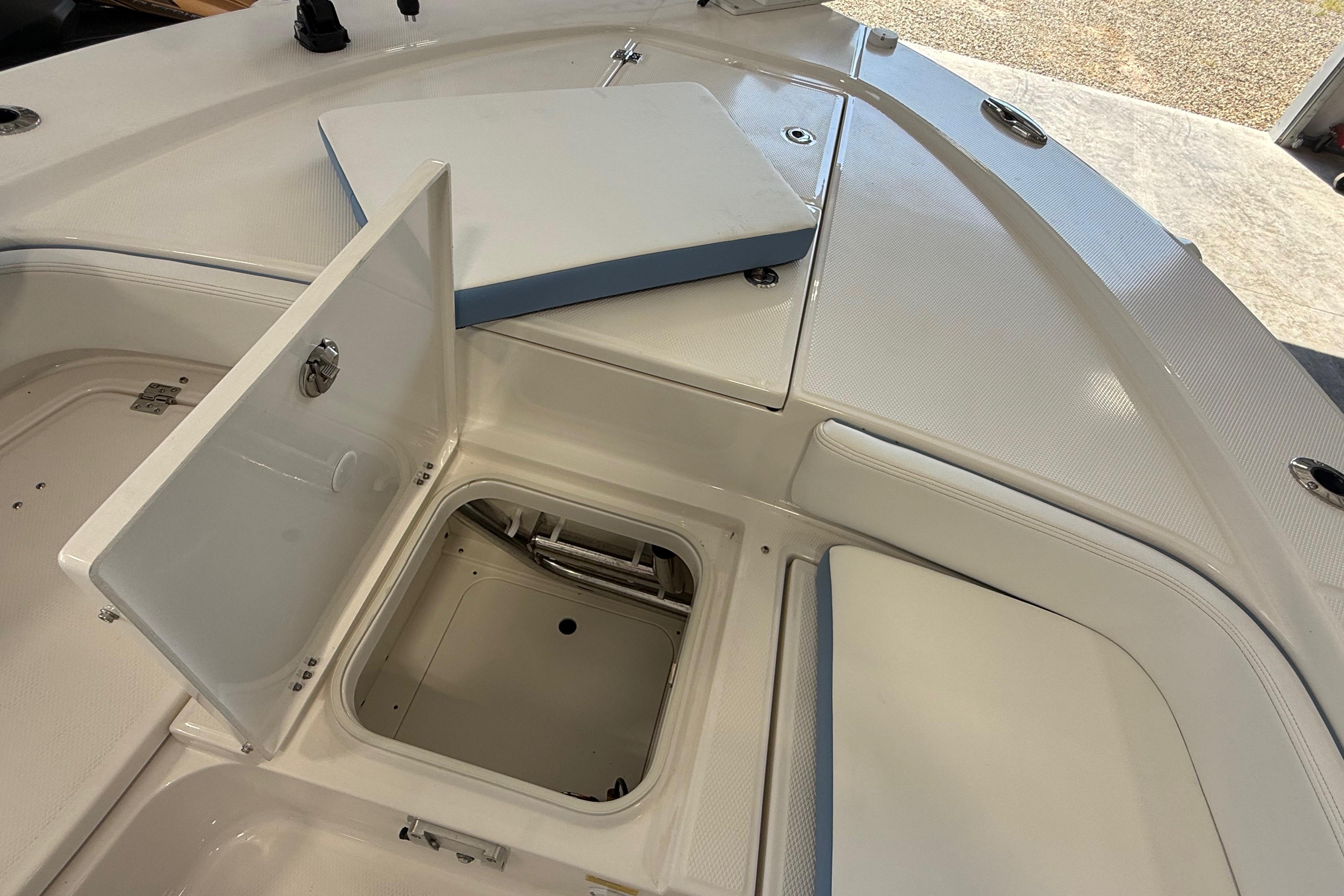 2026 Robalo 246 Cayman boat storage compartments and seating area.