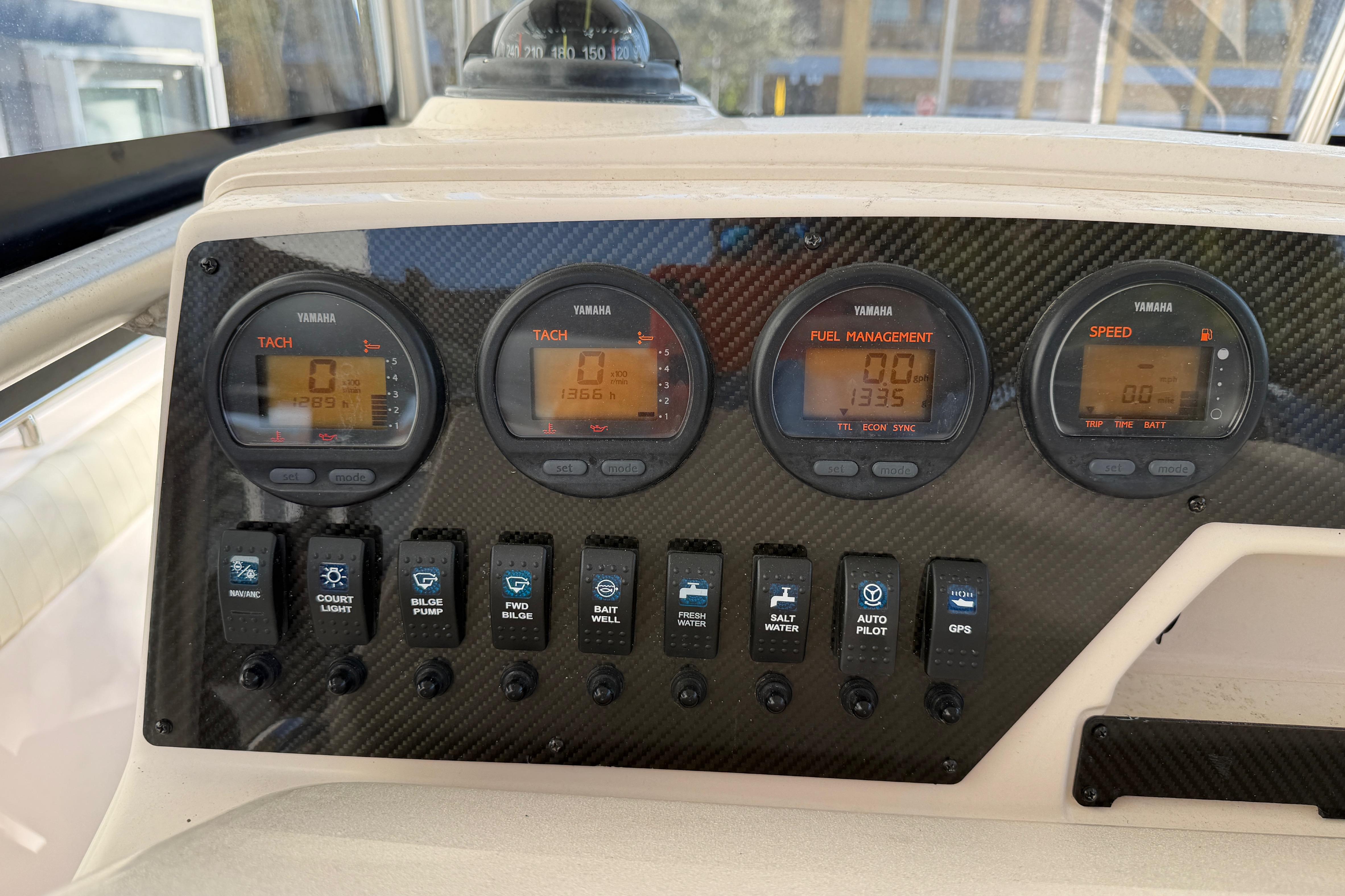 Dashboard of 2004 Grady White 273 boat with Yamaha gauges and control switches.