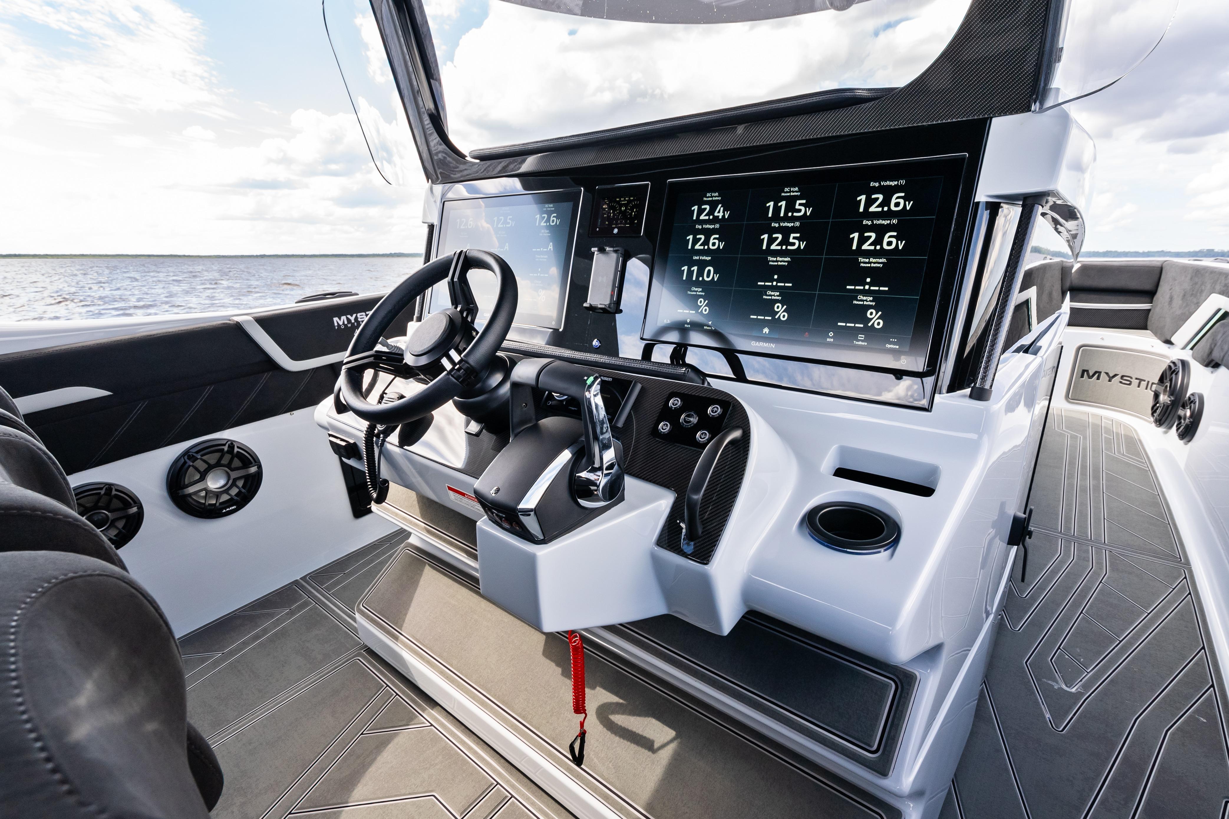 2027 Mystic Powerboats M4200 cockpit with advanced digital dashboard and sleek steering wheel.