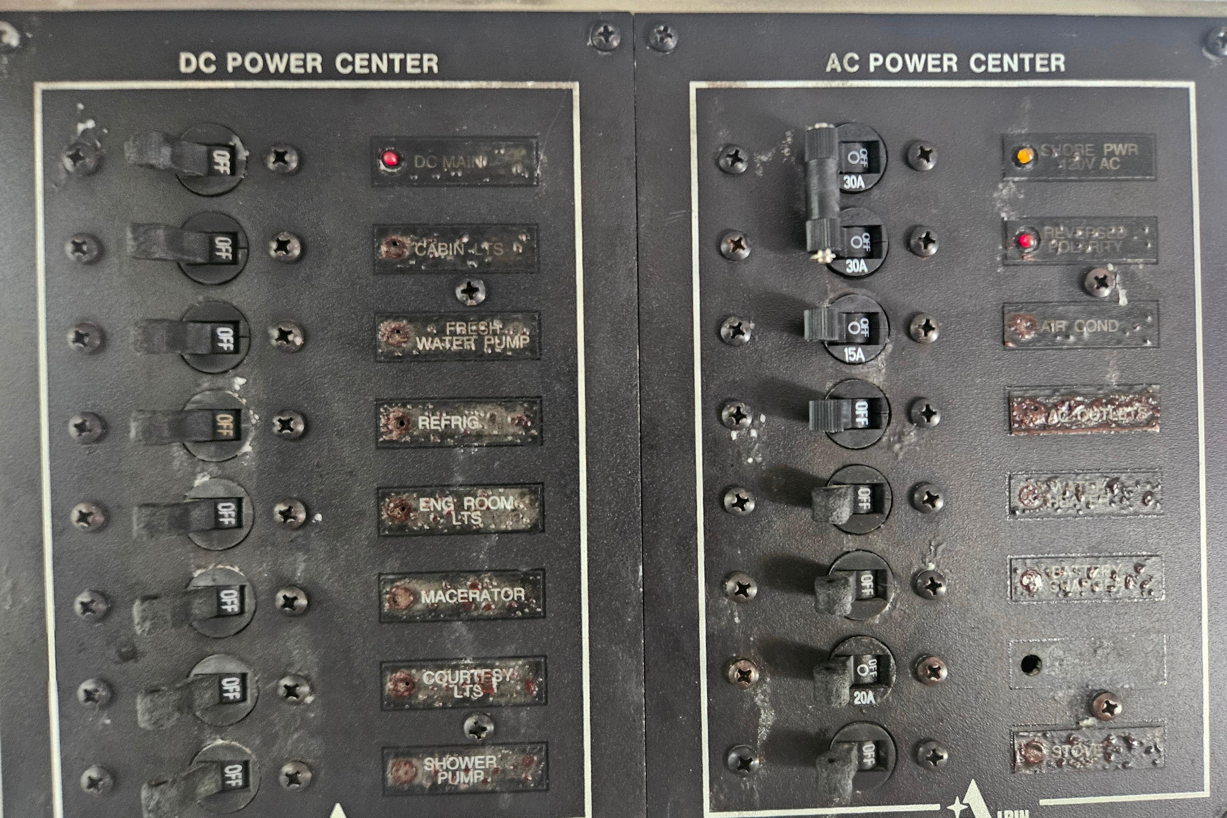 Control panel of a 1999 Albin 28 Tournament Express boat, showing DC and AC power centers.