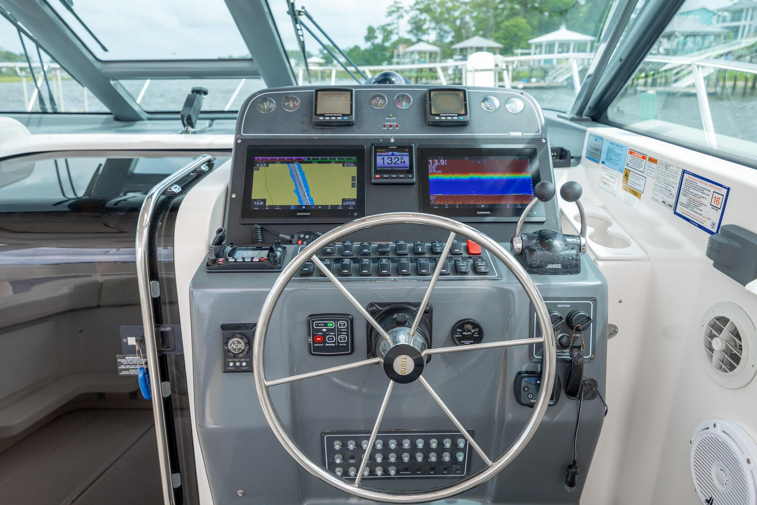Helm of 2004 Tiara Yachts 3200 Open with navigation displays and controls.