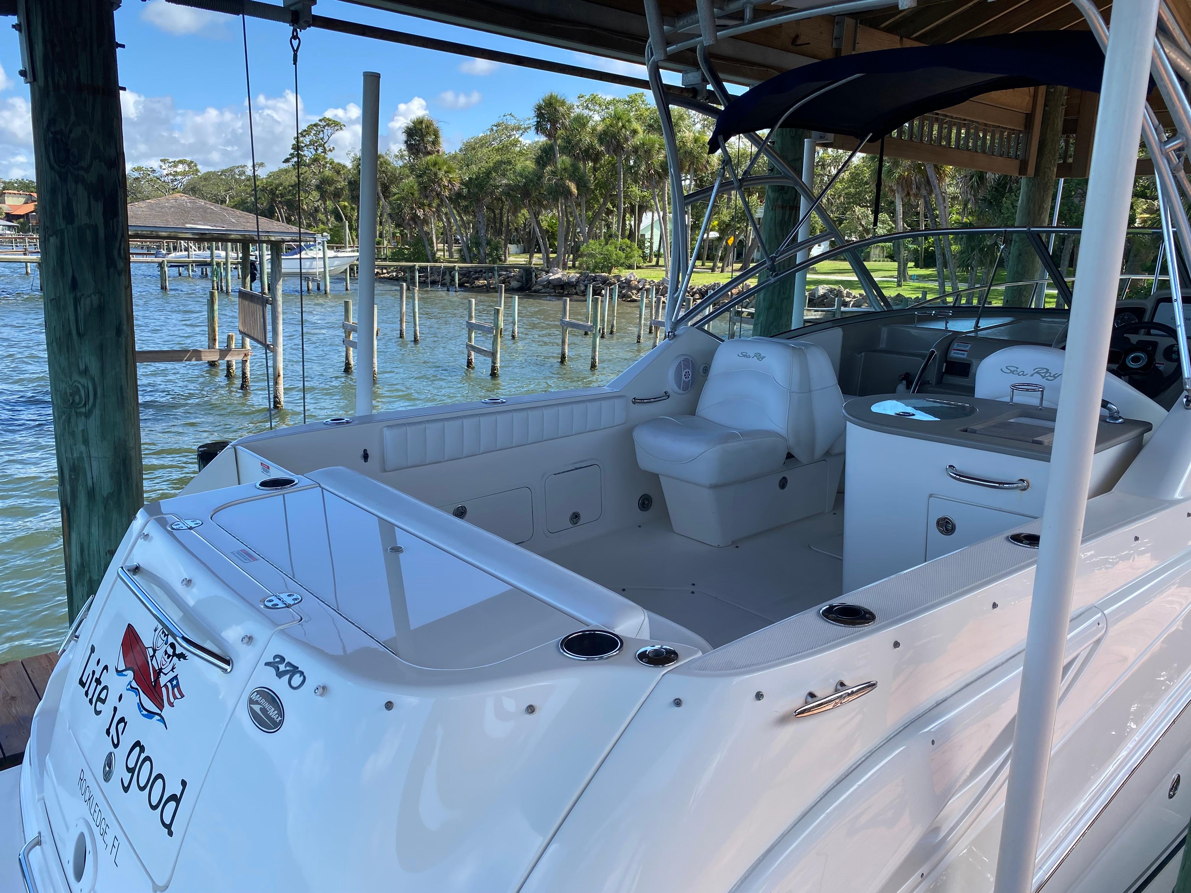 2008 Sea Ray 270 Amberjack boat docked, featuring spacious seating and scenic waterfront view.