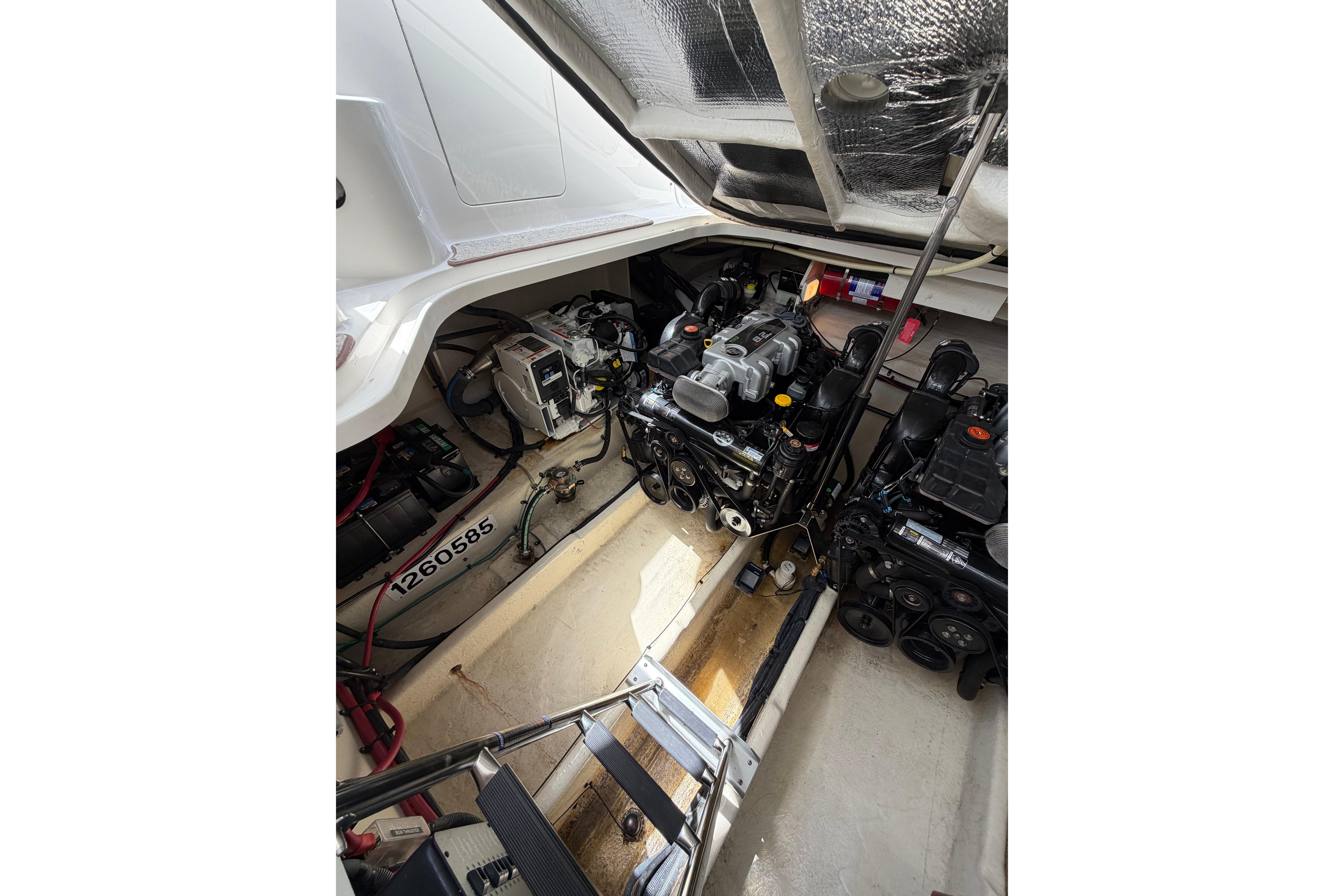 Engine compartment of a 2012 Sea Ray Sundancer 370, showcasing mechanical components and wiring.