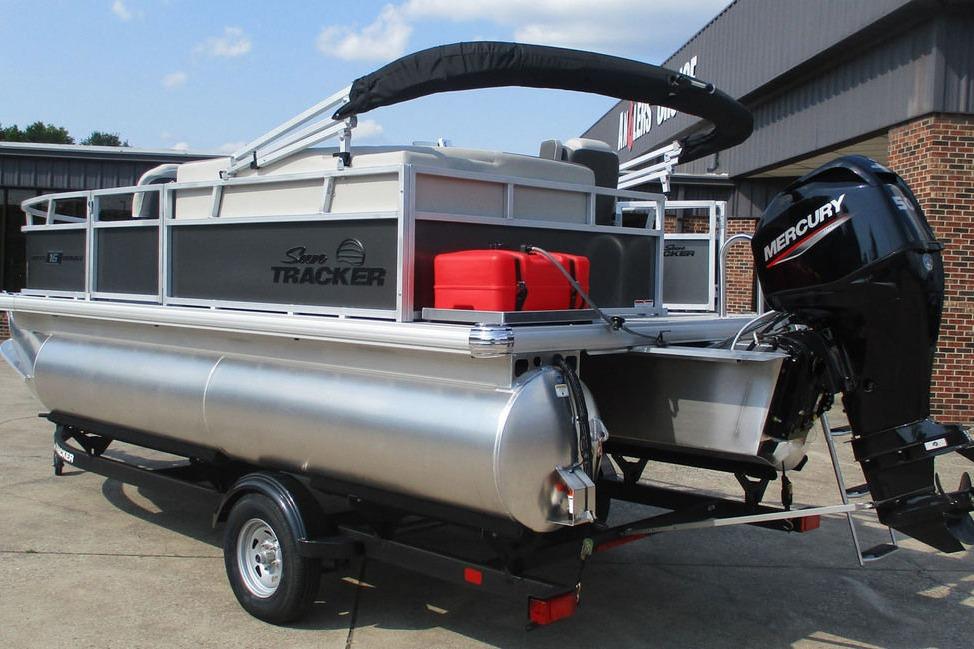 2026 Sun Tracker Bass Buggy 16 XL Select pontoon boat with Mercury outboard motor on trailer.