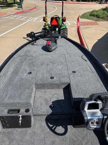 2025 Tracker Savage 215 boat interior with steering console and carpeted deck.