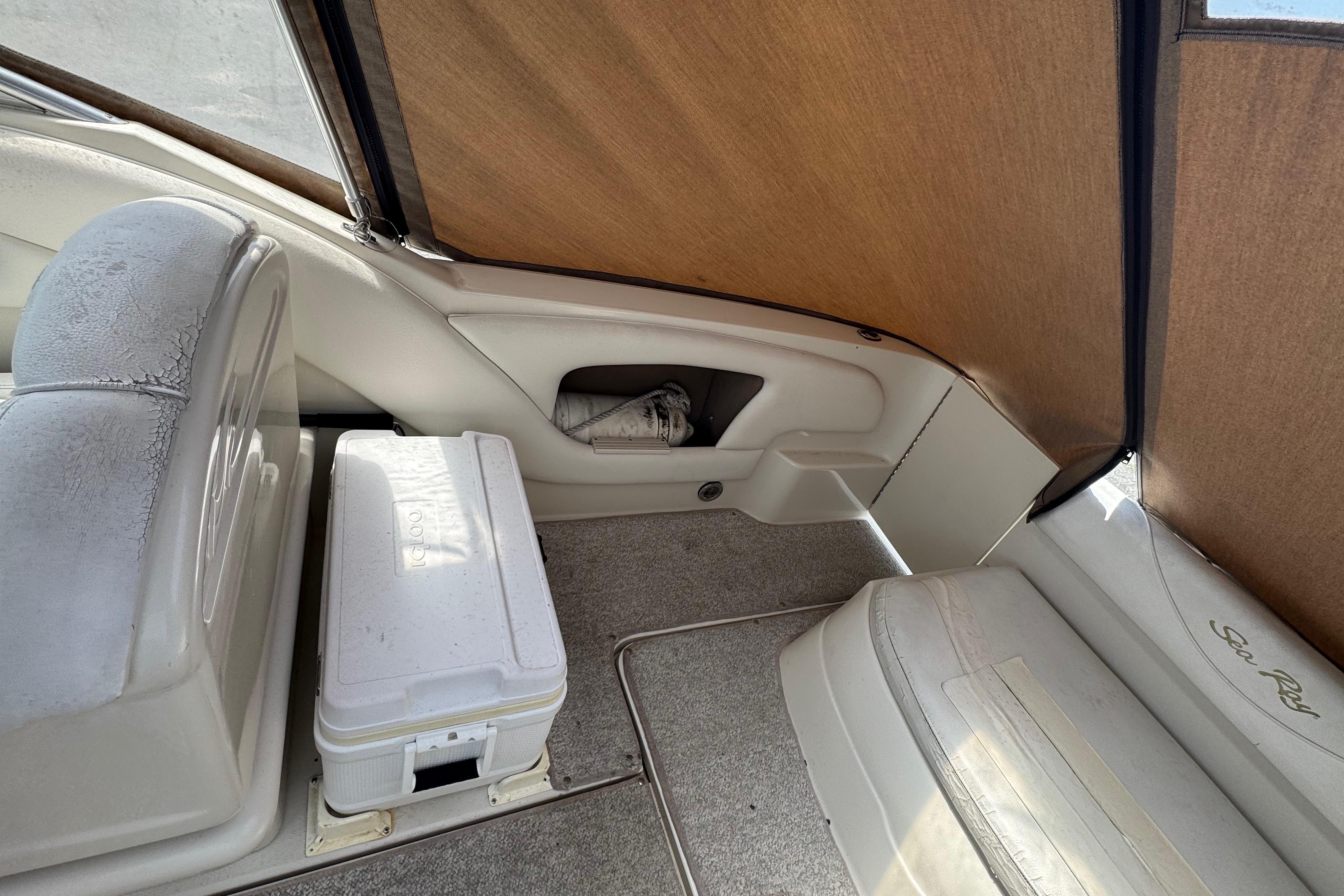 Interior of 2001 Sea Ray 245 Weekender boat with seating and cooler.