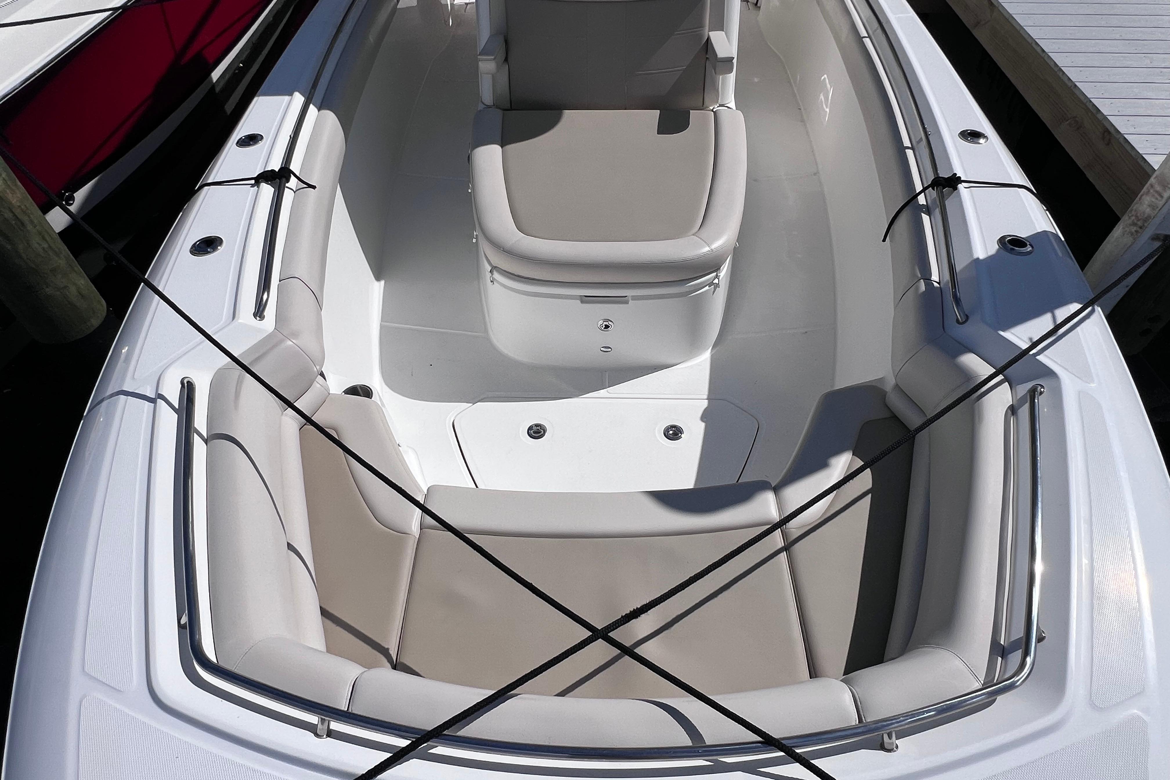 2021 Boston Whaler 330 Outrage boat interior with cushioned seating and sleek design.