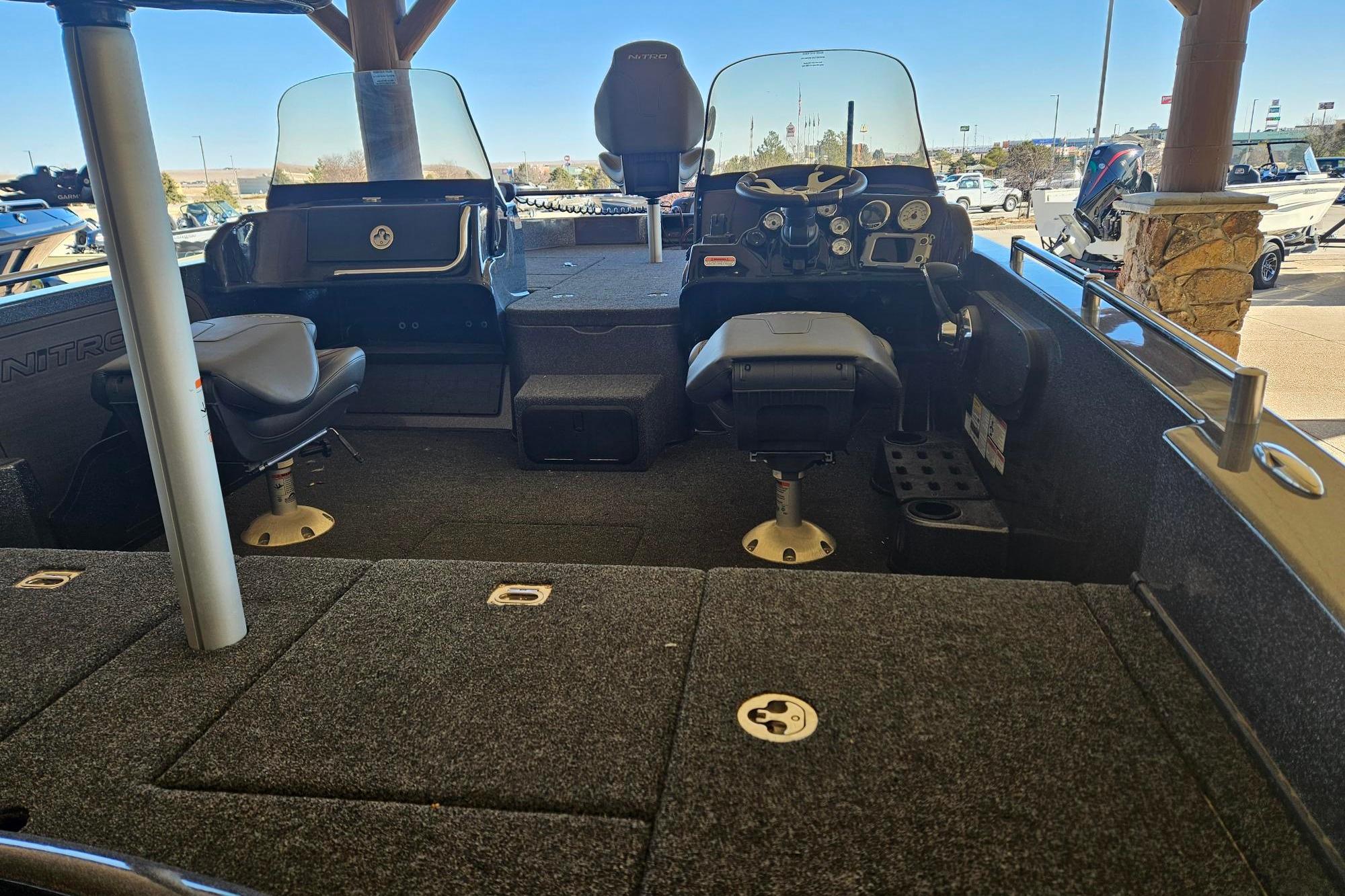 Interior of a 2025 Nitro ZV19 boat with seating and control panel.