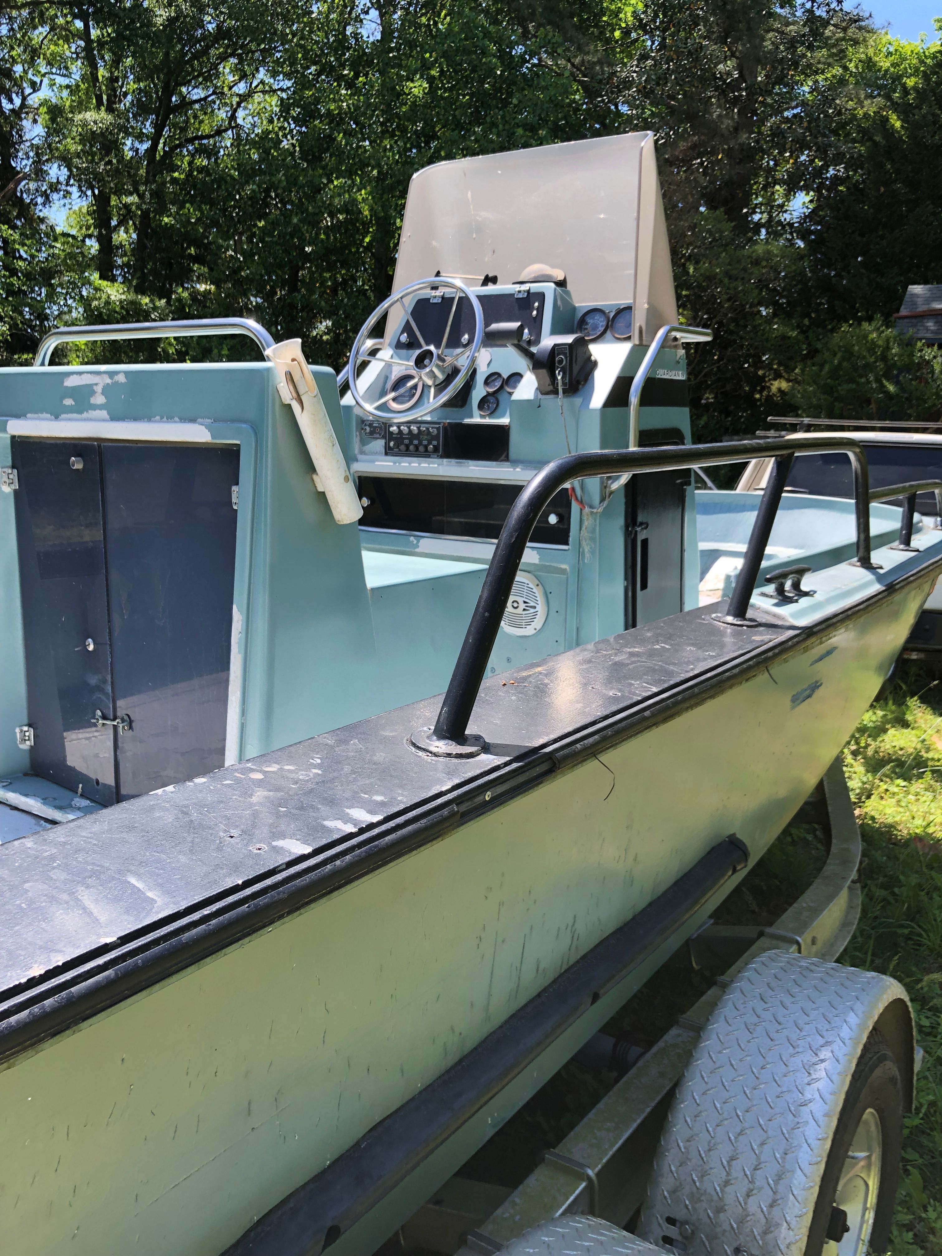 A 1991 Boston Whaler Guardian is on a trailer outdoors.