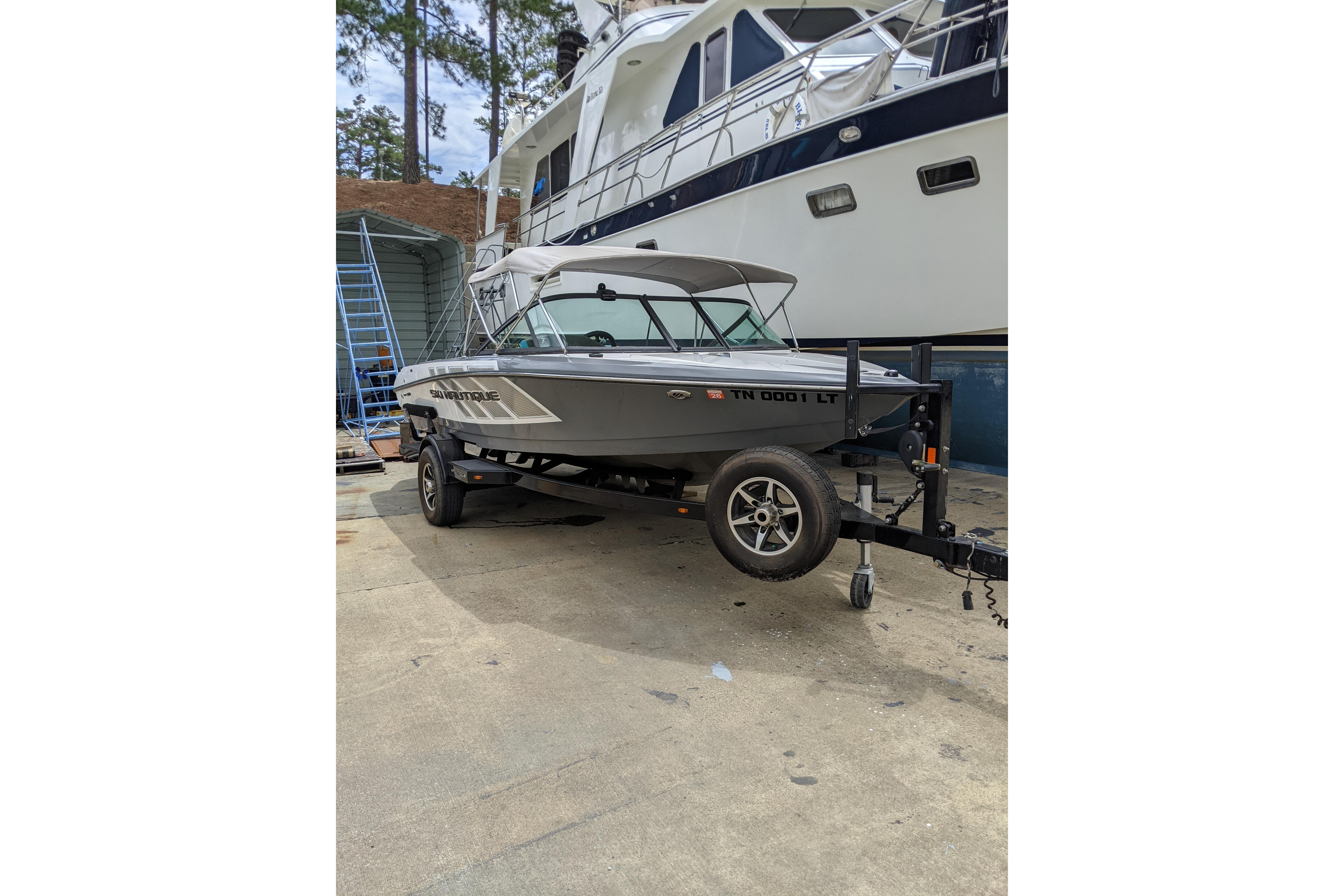 2016 Nautique Ski Nautique 200 Closed Bow boat on trailer, parked outdoors.