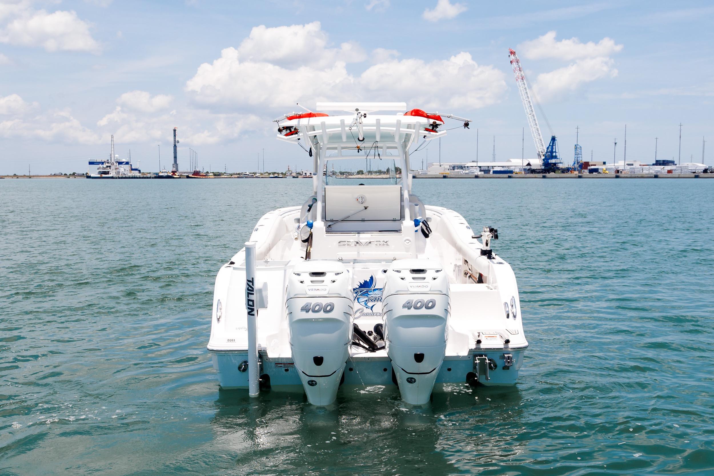 Sea Fox 328 Commander 2021 boat on water, twin engines, industrial background.