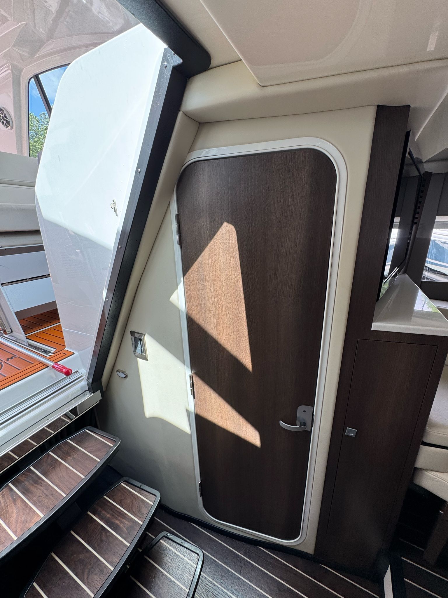Interior of 2015 Monterey 360 Sport Coupe with wooden door and stairs.