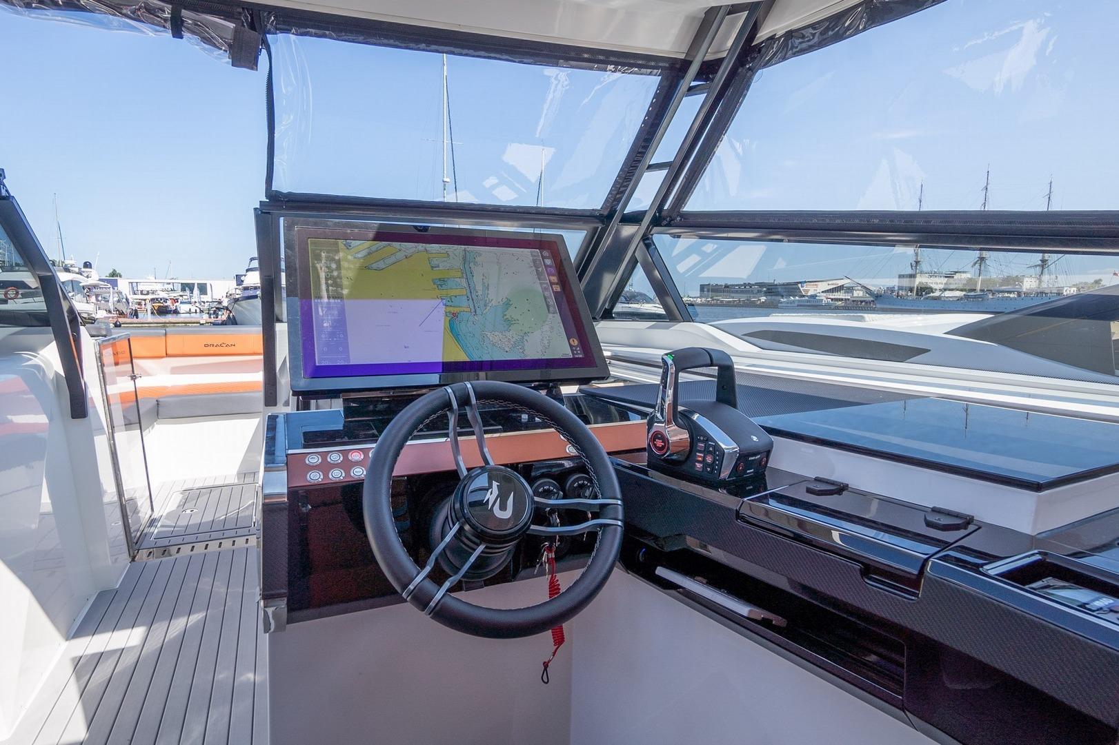 Modern helm of 2026 Dracan 42 Catamaran with navigation display and controls.