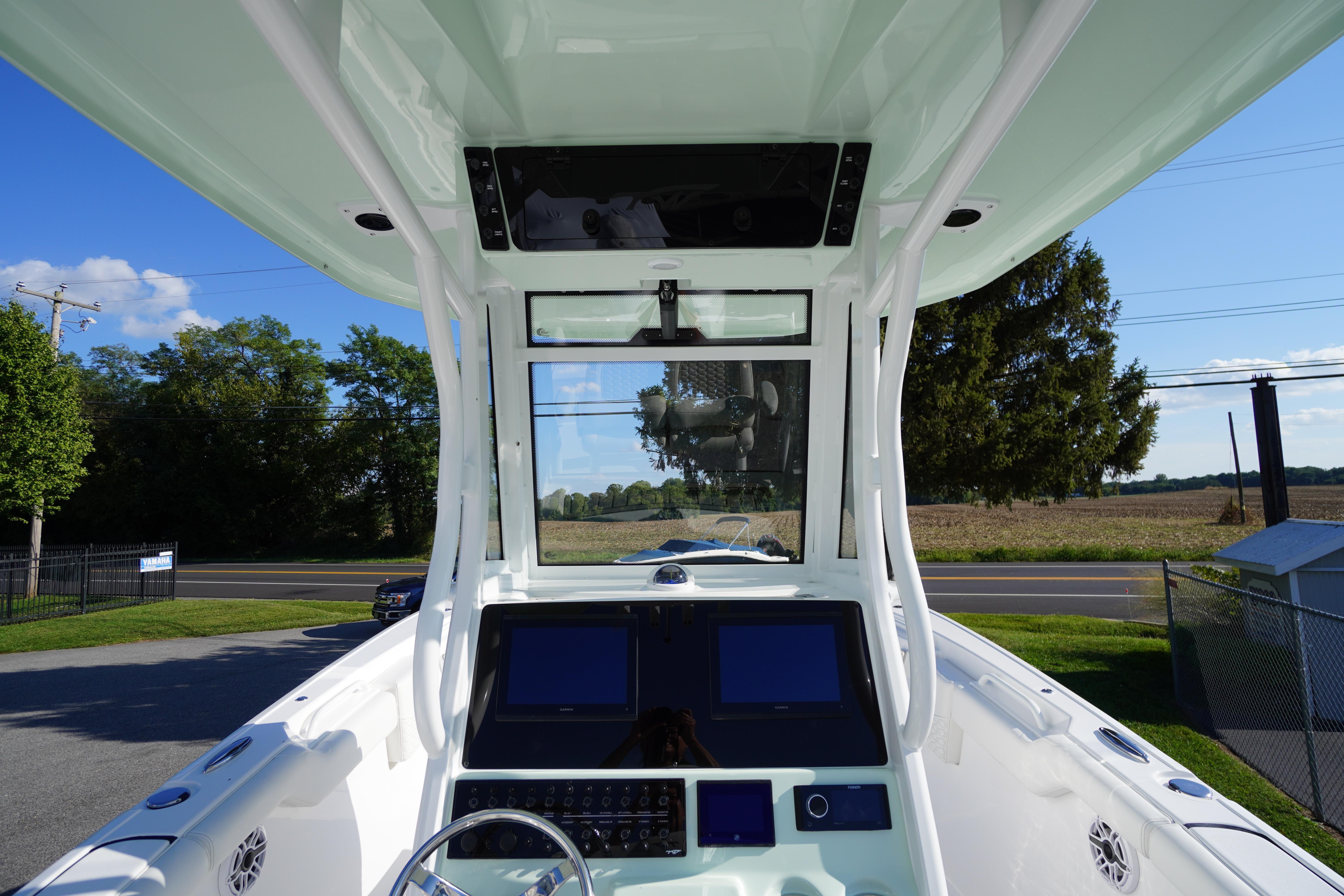 2026 Tidewater 272 LXF boat dashboard with dual screens and steering wheel.