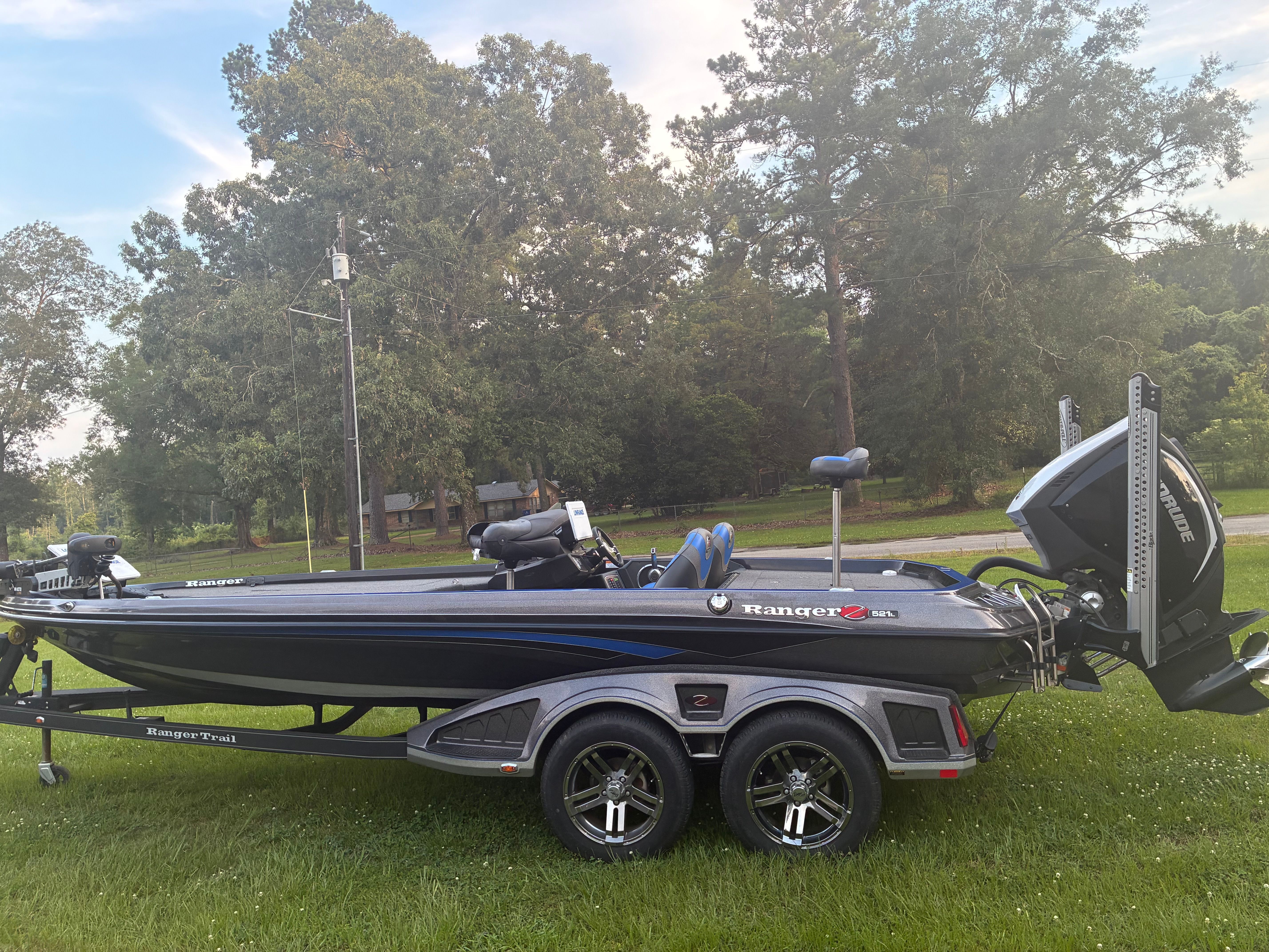 2020 Ranger Z521R boat parked on grass with trees in background.
