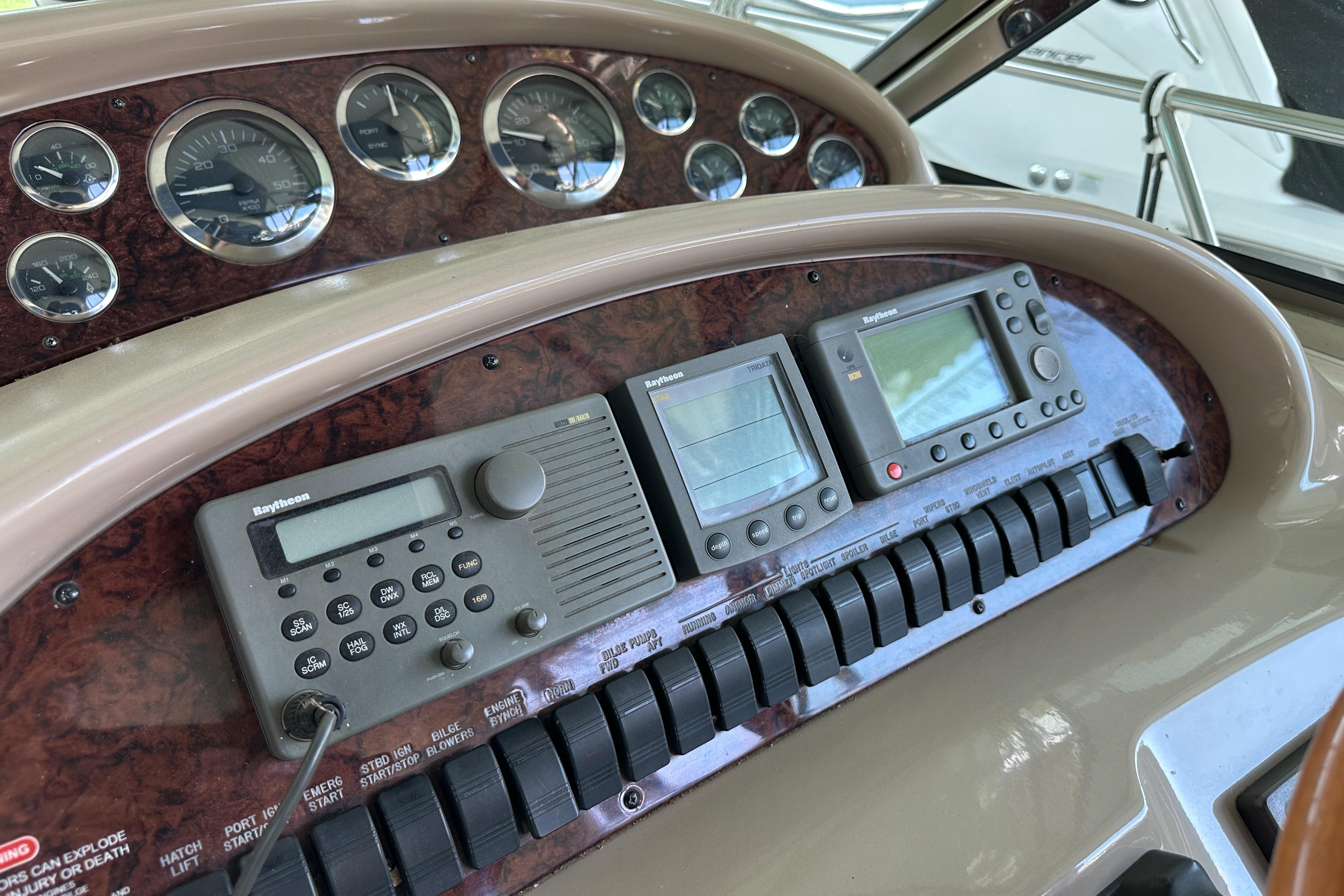 Dashboard of a 2001 Sea Ray 410 Sundancer with navigation instruments and gauges.