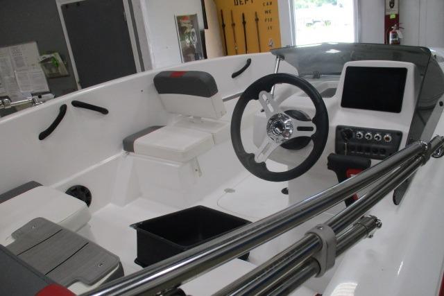 2024 Tahoe T16 boat interior with steering wheel and seating, showcasing modern design.