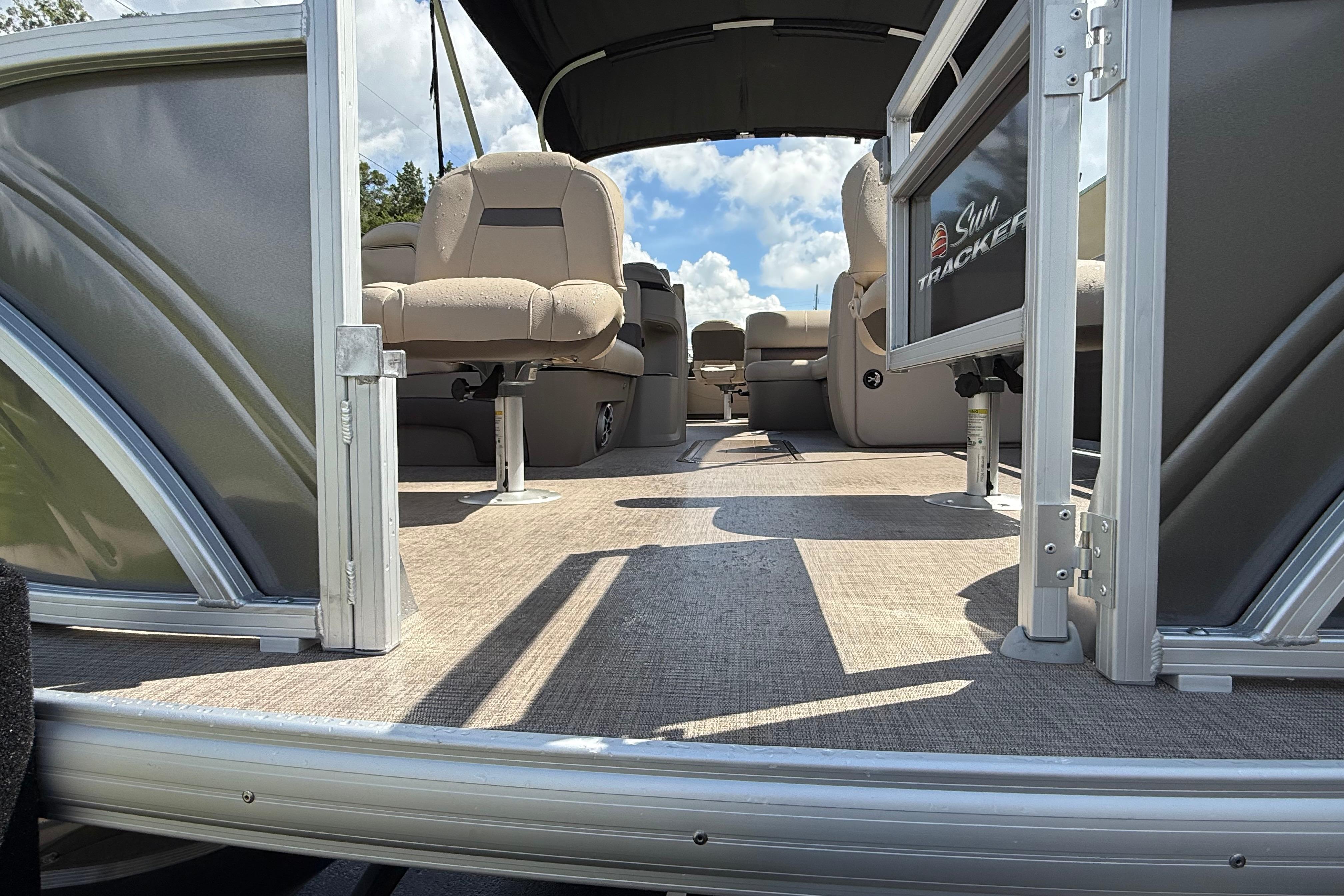 2025 Sun Tracker Fishin' Barge 22 XP3 interior with seating and open deck view.