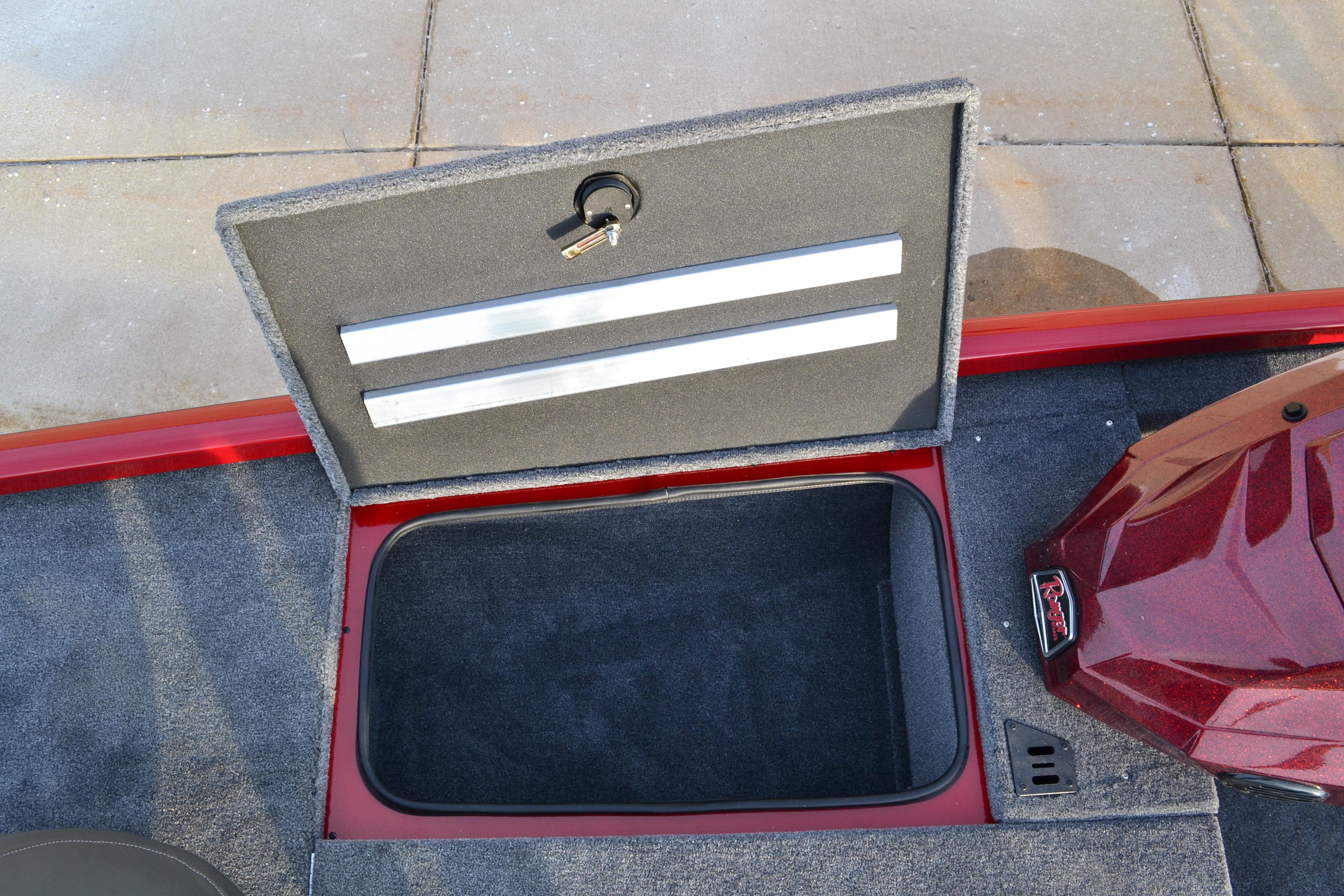 Open storage compartment on 2026 Ranger RT188 boat with carpeted interior and key lock.