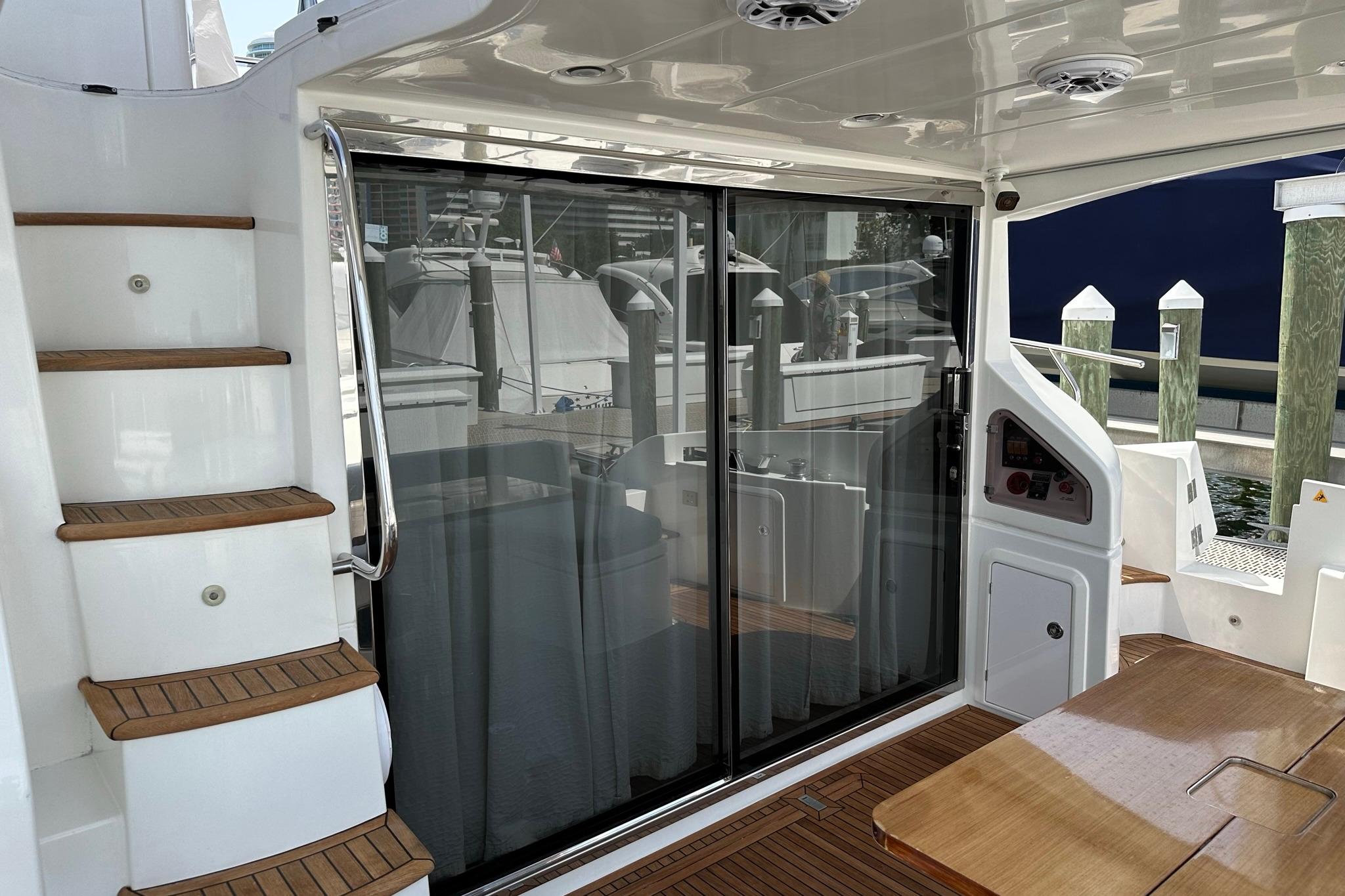 Azimut Fly 53 yacht deck with wooden stairs and sliding glass doors, 2013 model.